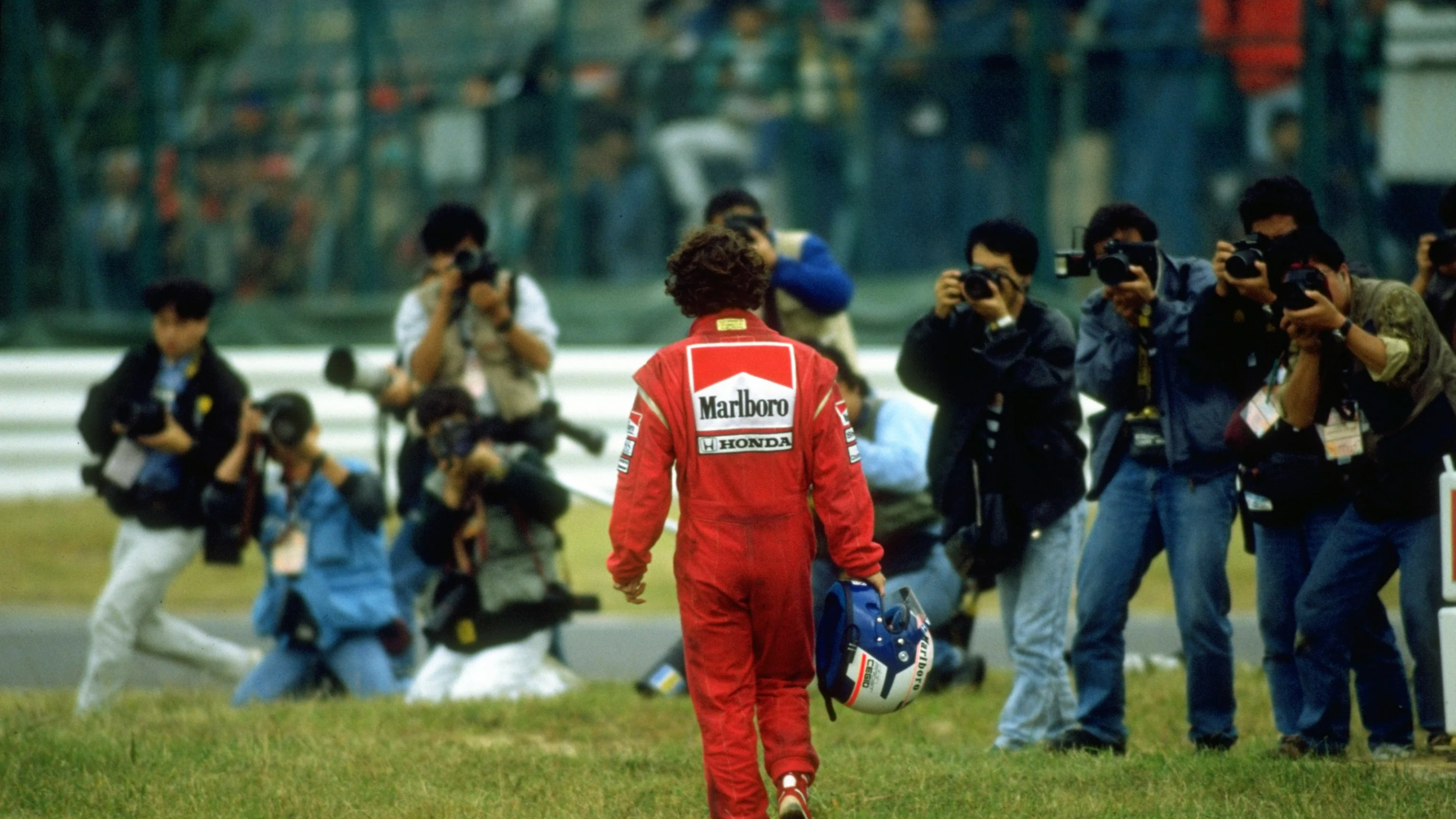 Photographers wait as Alain Prost of France, driver of the #2 Marlboro McLaren-Honda MP4/5Honda
