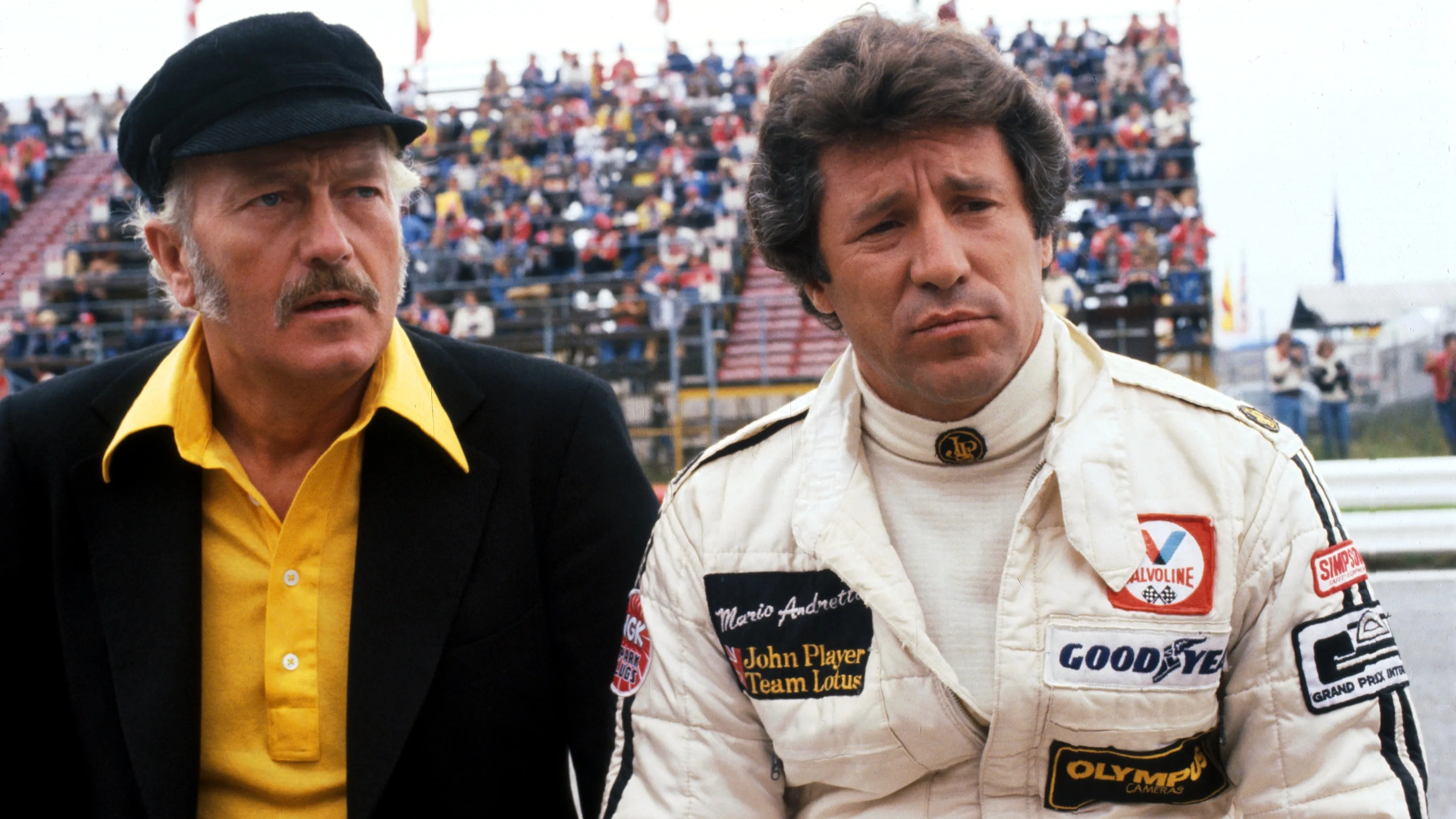 (L to R): Colin Chapman (GBR) Lotus Team Owner with Mario Andretti (USA) Lotus who crashed out on