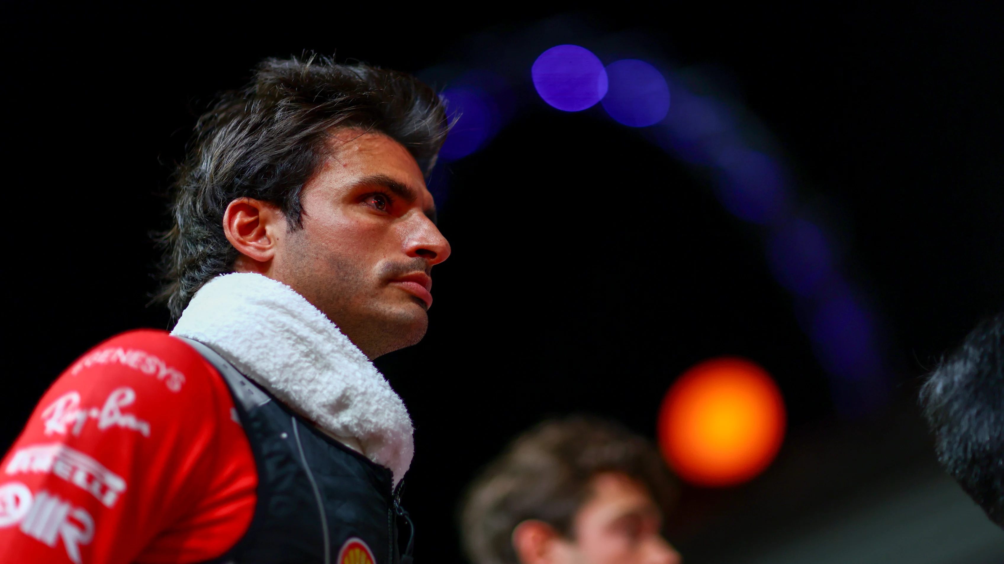 SINGAPORE, SINGAPORE - SEPTEMBER 17: Carlos Sainz of Spain and Ferrari looks on from the grid prior