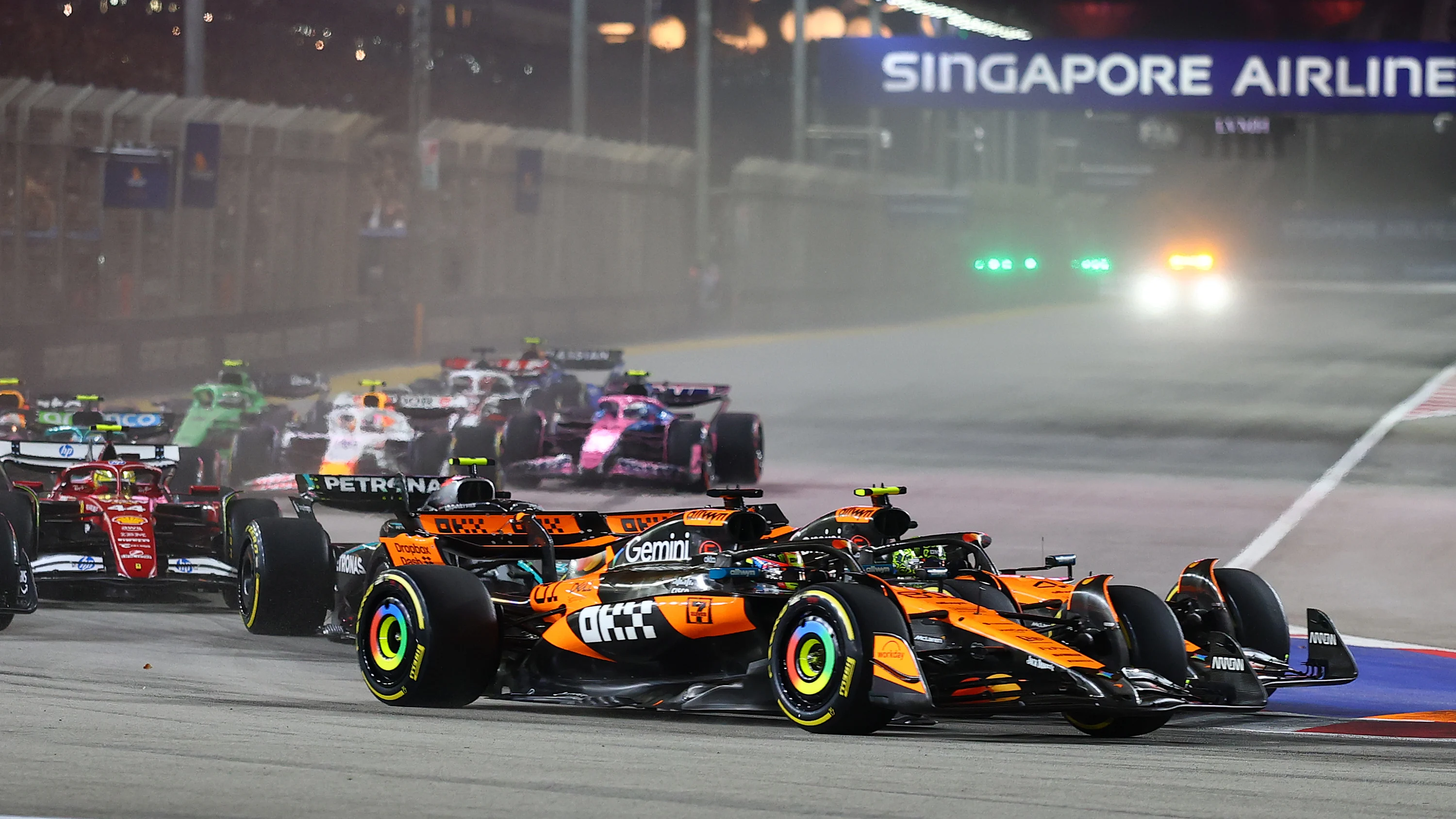 SINGAPORE, SINGAPORE - OCTOBER 05: Lando Norris of Great Britain driving the (4) McLaren MCL39 Mercedes and Oscar Piastri of Australia driving the (81) McLaren MCL39 Mercedes battle for track position at the start during the F1 Grand Prix of Singapore at Marina Bay Street Circuit on October 05, 2025 in Singapore, Singapore. (Photo by Bryn Lennon/Getty Images)