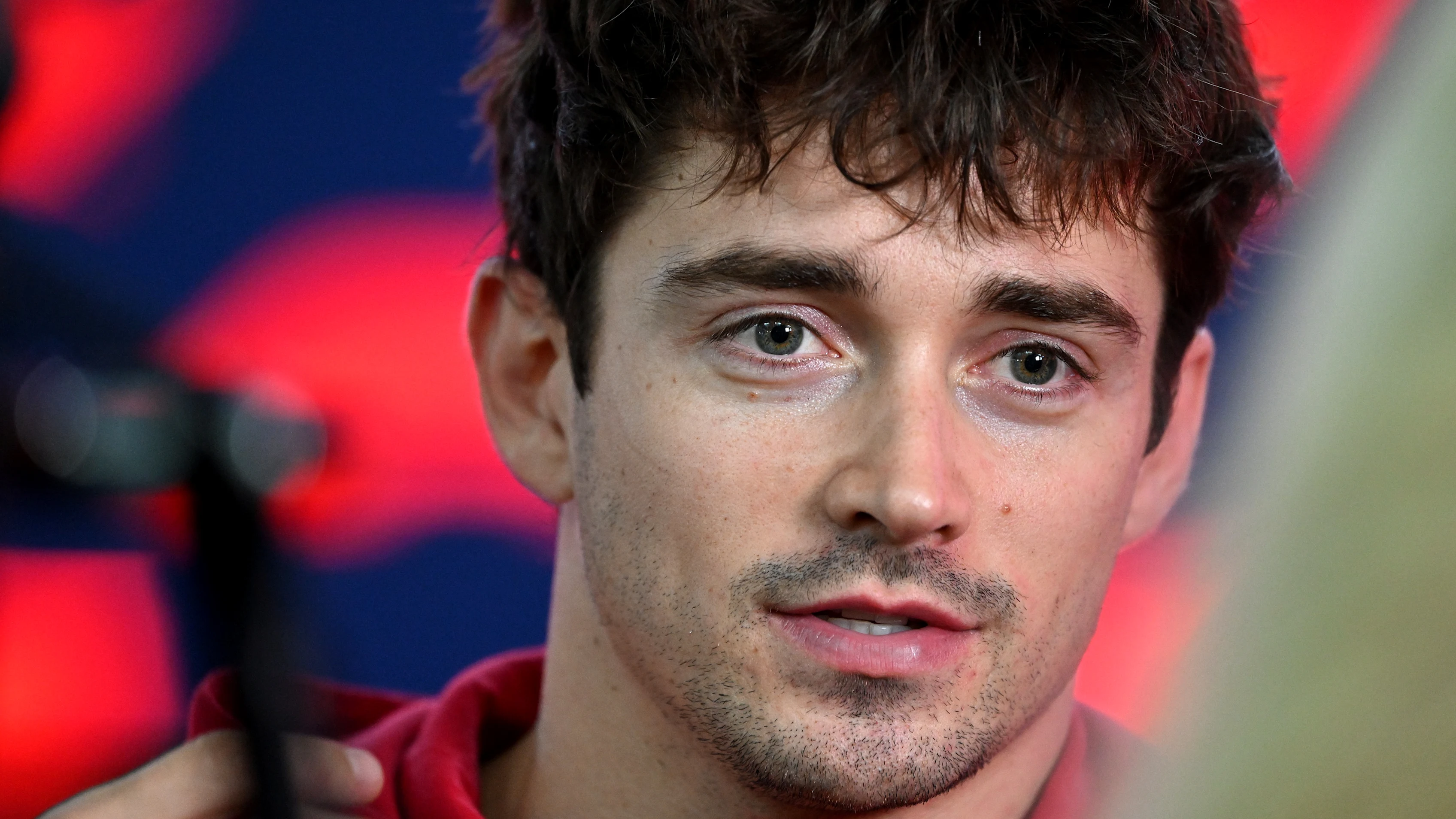 SINGAPORE, SINGAPORE - OCTOBER 03: Charles Leclerc of Monaco and Scuderia Ferrari is interviewed