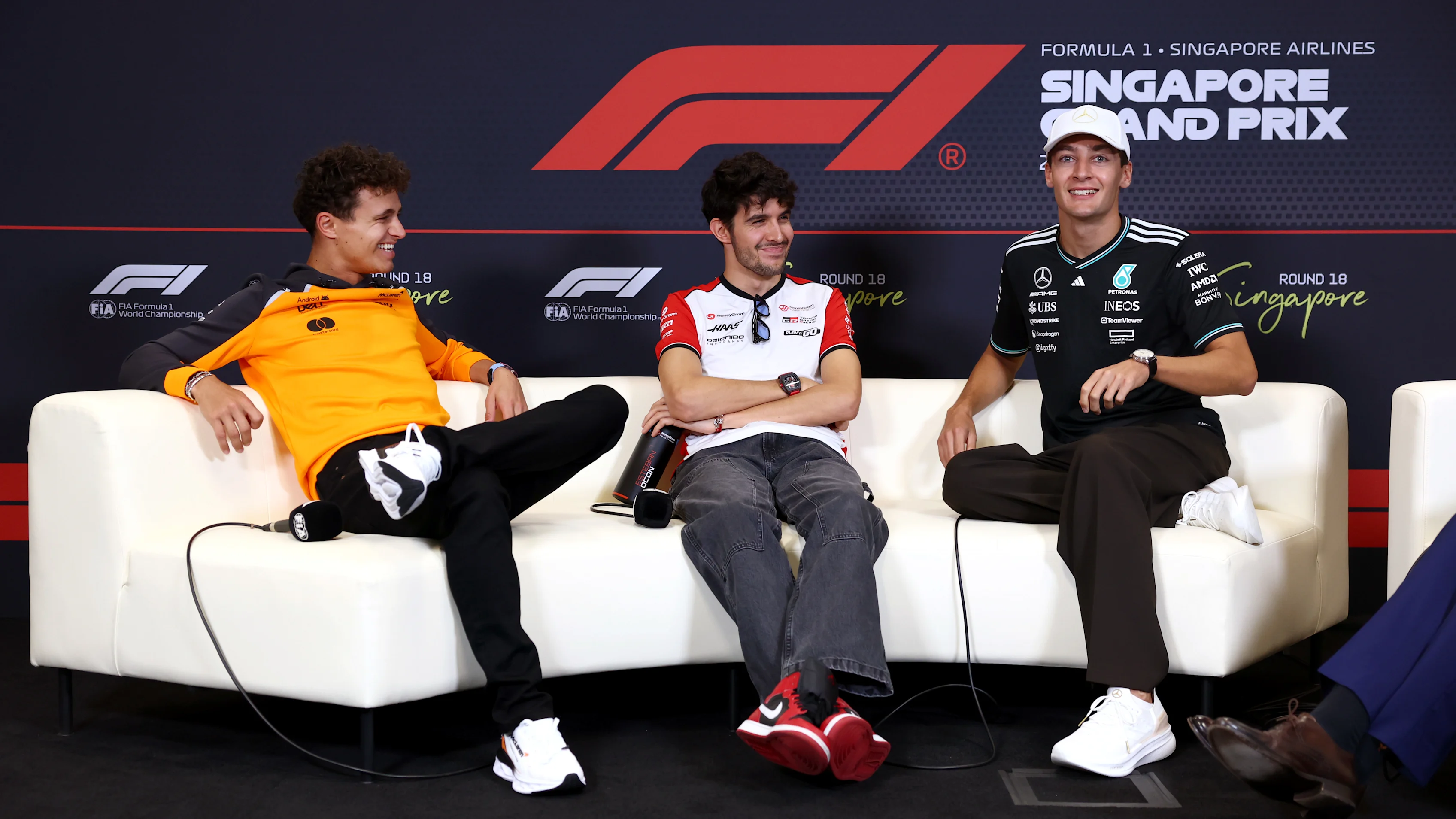 SINGAPORE, SINGAPORE - OCTOBER 02: Lando Norris of Great Britain and McLaren, Esteban Ocon of