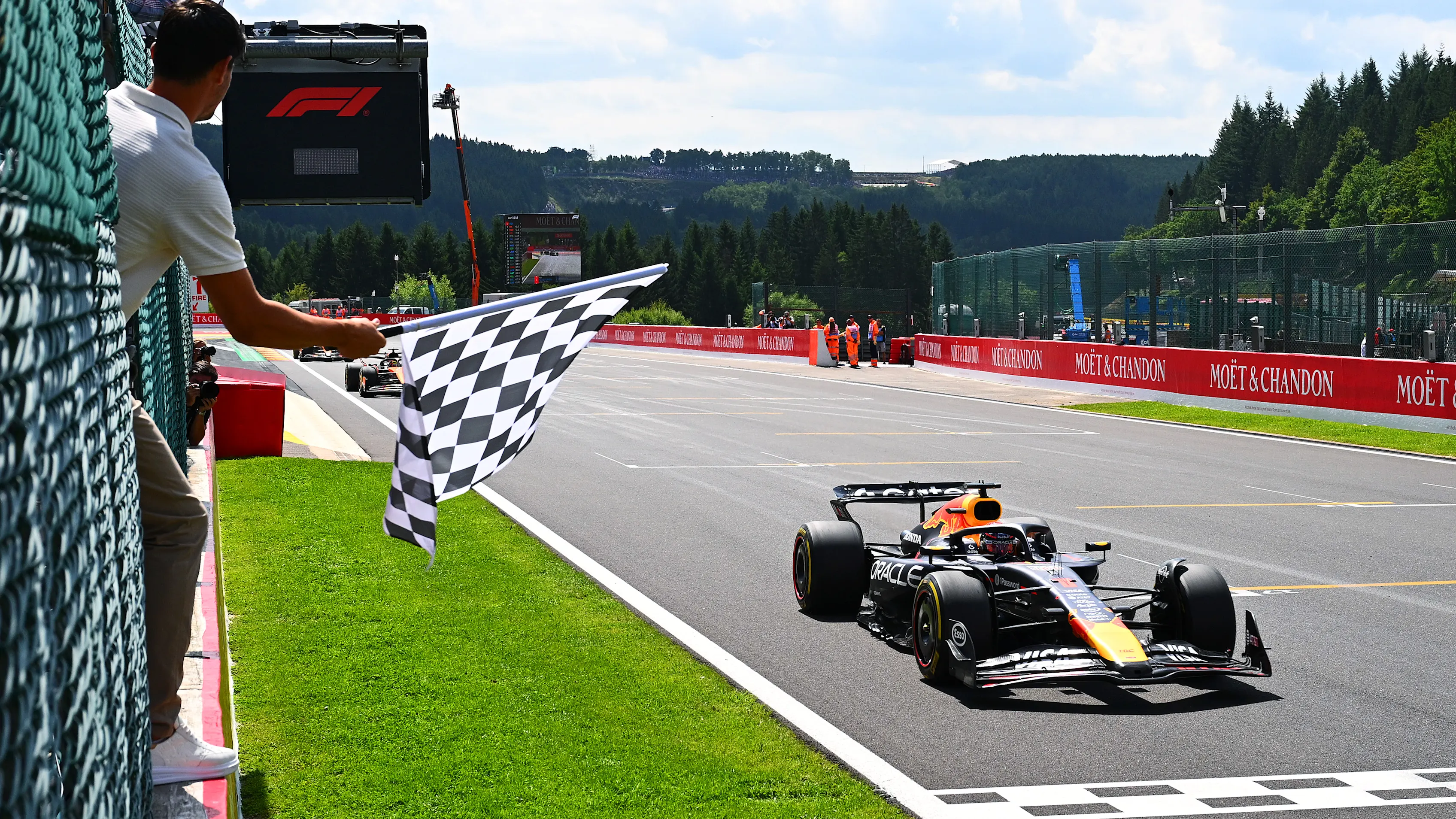 SPA, BELGIUM - JULY 26: Sprint winner Max Verstappen of the Netherlands driving the (1) Oracle Red Bull Racing RB21 takes the chequered flag waved by Thibaut Courtois during the Sprint ahead of the F1 Grand Prix of Belgium at Circuit de Spa-Francorchamps on July 26, 2025 in Spa, Belgium. (Photo by Mark Sutton - Formula 1/Formula 1 via Getty Images)