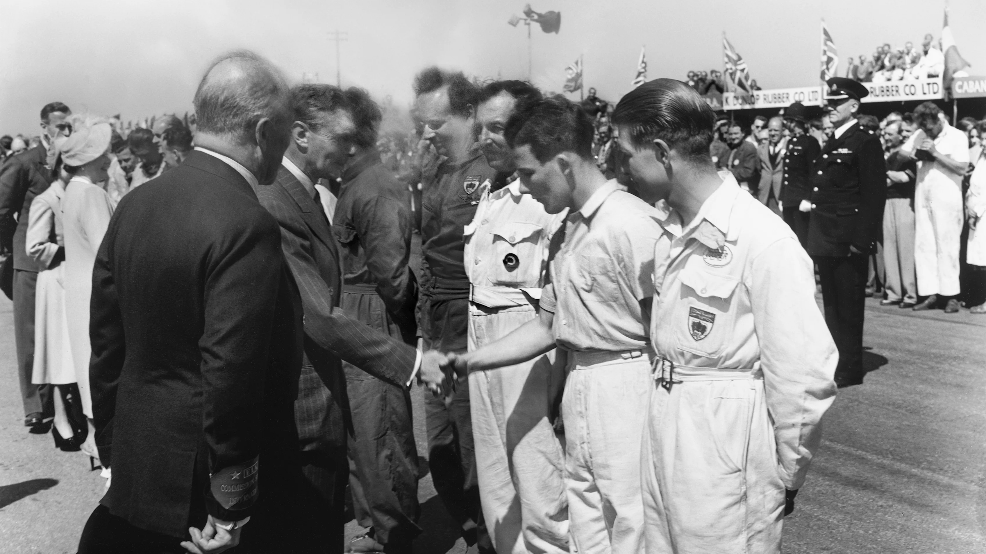 King George VI meets the drivers, including a young Stirling Moss, who finished second in a support race