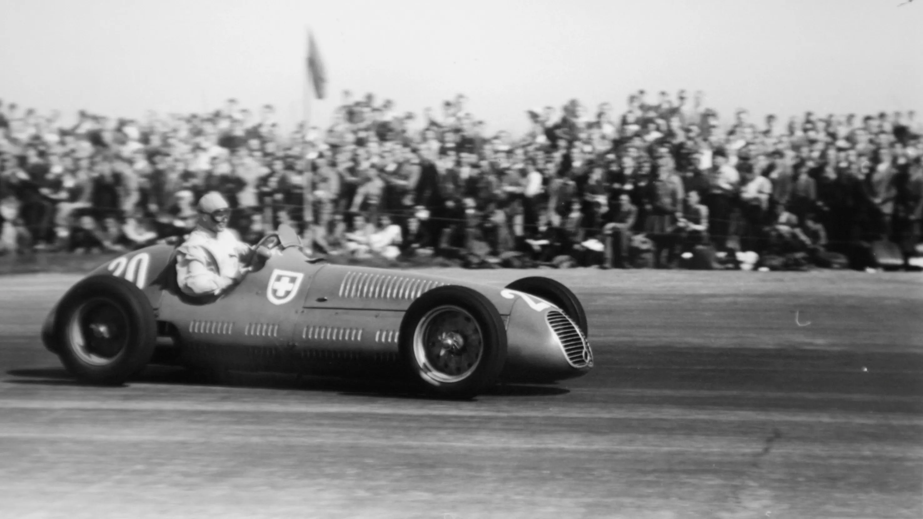 Baron Emmanuel de Graffenried drives his Maserati around Silverstone’s high-speed sweeps