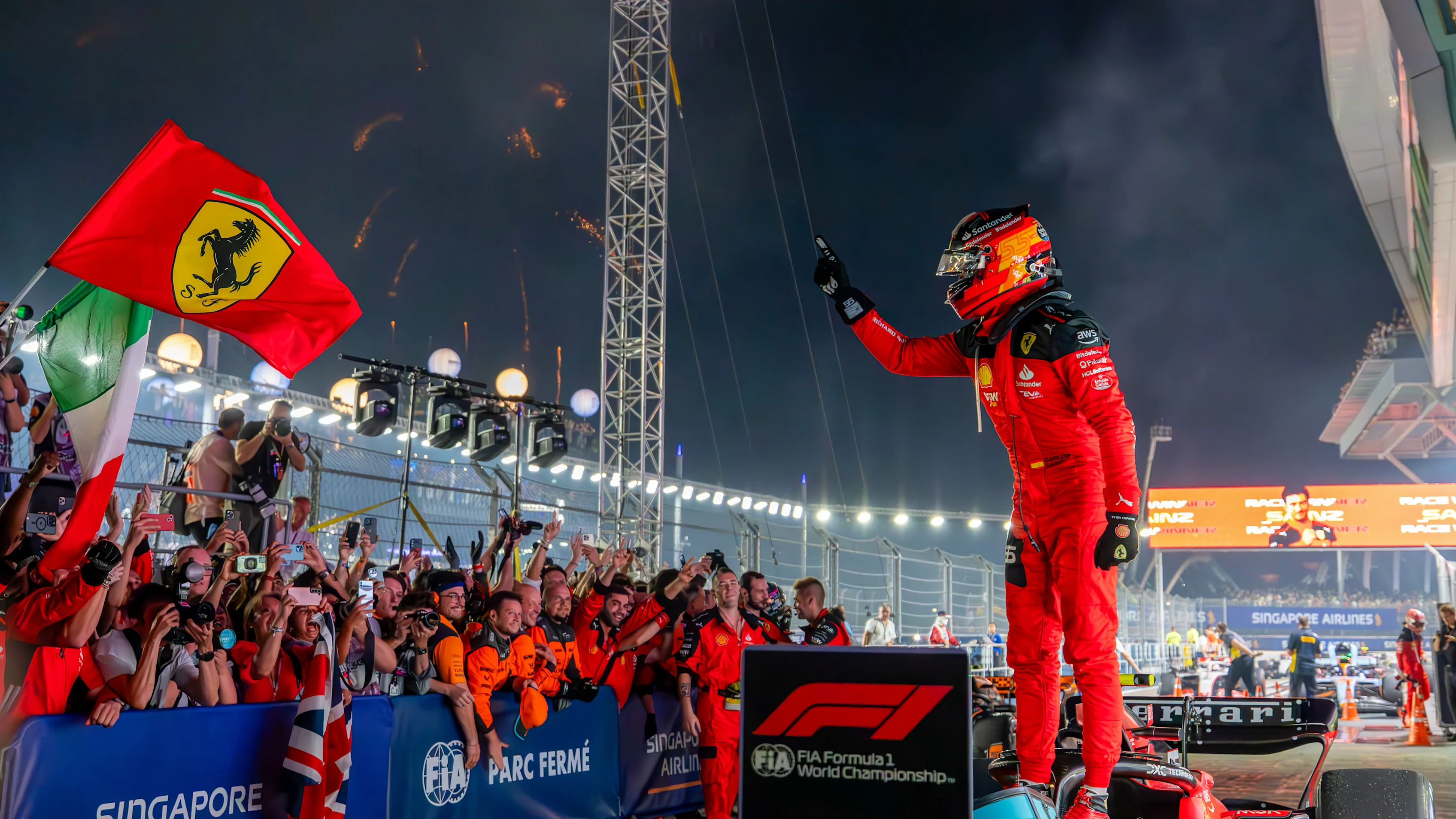 SINGAPORE, SINGAPORE - SEPTEMBER 17: Carlos Sainz Jr of Spain and Scuderia Ferrari celebrates his