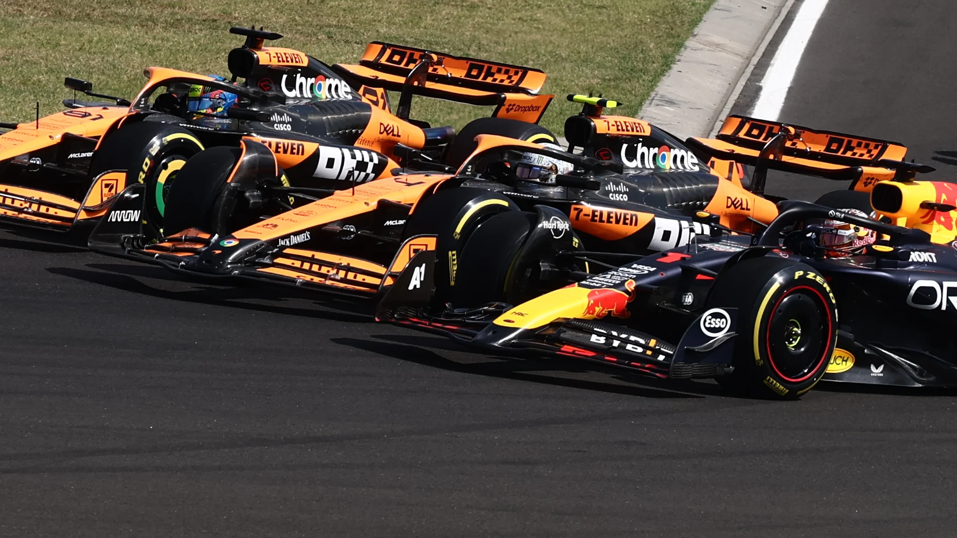 Max Verstappen of Red Bull Racing, Lando Norris and Oscar Piastri of McLaren at start of the