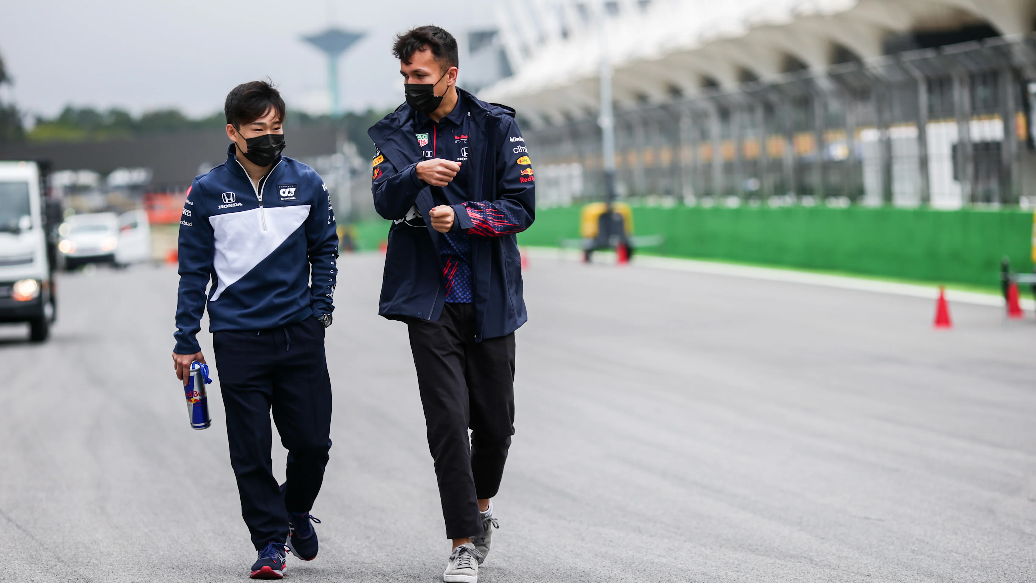 SAO PAULO, BRAZIL - NOVEMBER 11: Yuki Tsunoda of Scuderia AlphaTauri and Japan with Alex Albon of