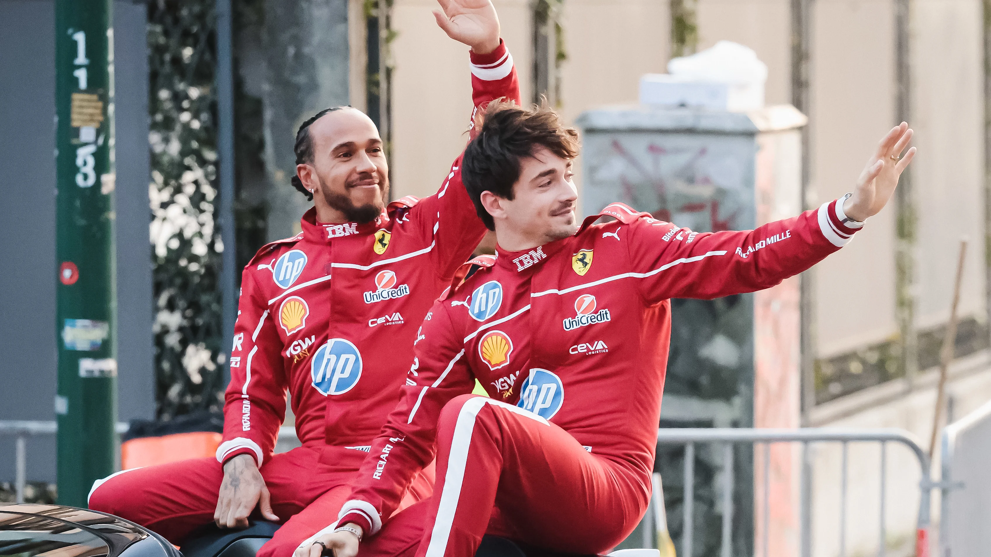 Lewis Hamilton and Charles Leclerc attend the street parade during the Scuderia Ferrari HP Drivers'
