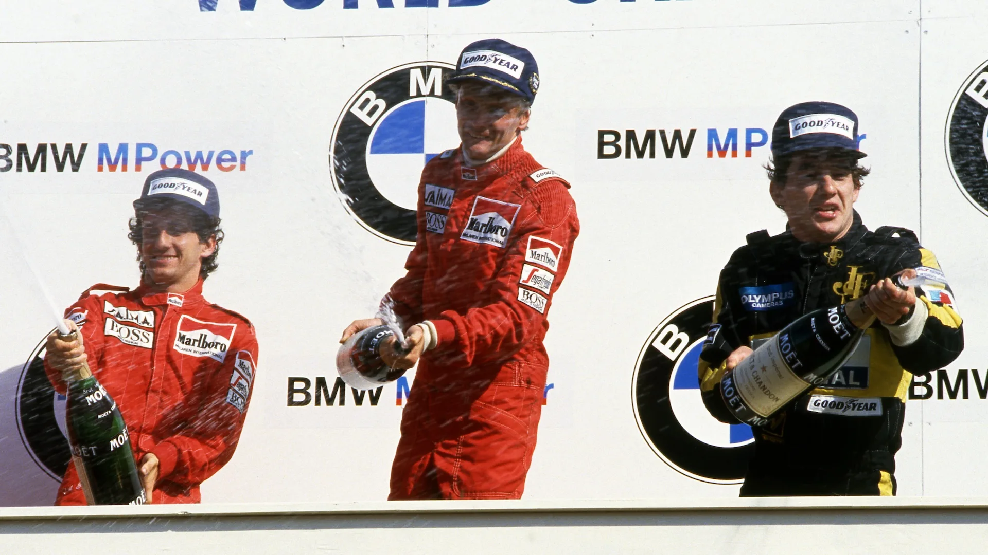 (L to R): Second placed Alain Prost (FRA) McLaren, race winner Niki Lauda (AUT) McLaren and third