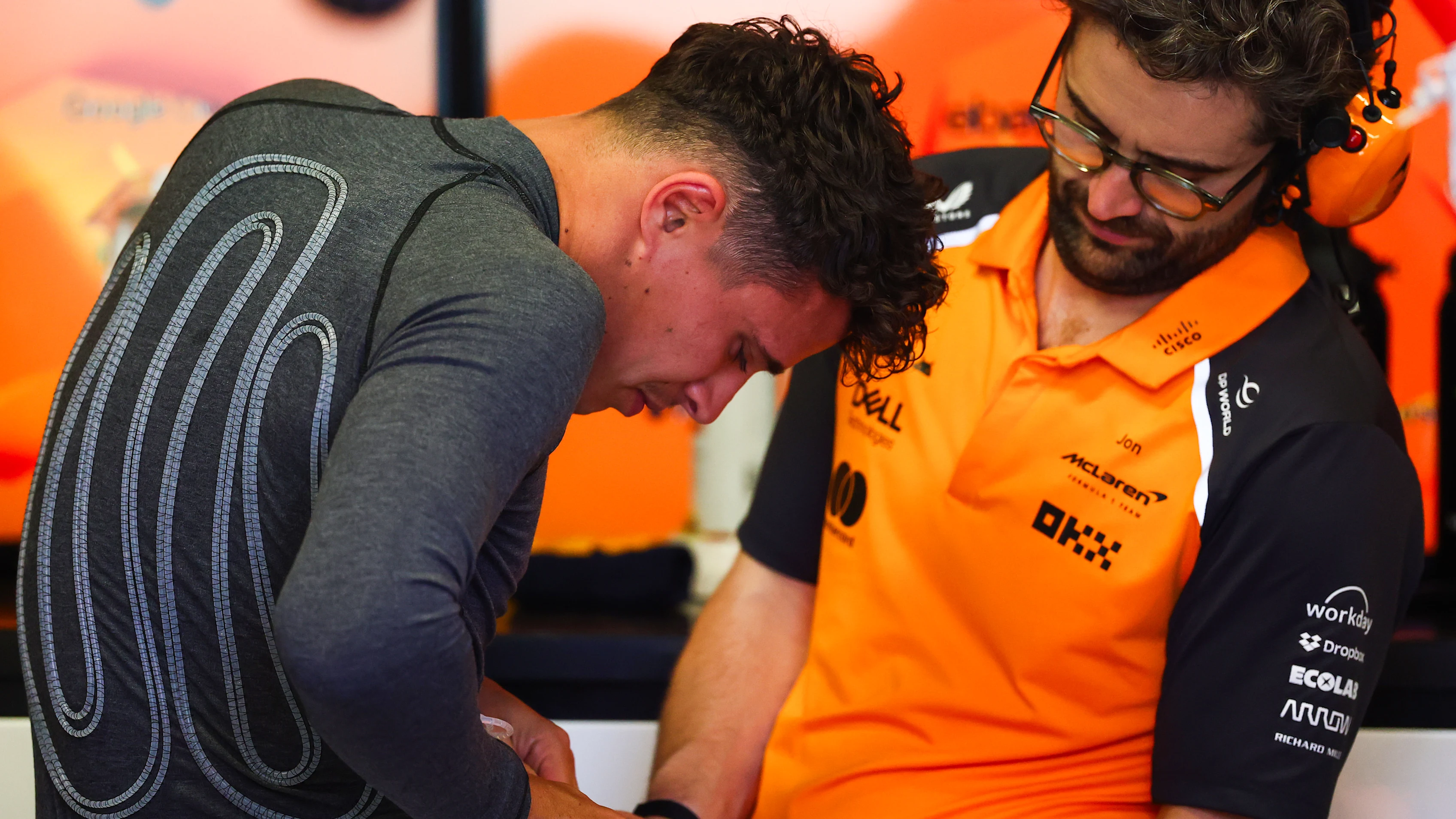 BARCELONA, SPAIN - MAY 30: Lando Norris of Great Britain and McLaren attaches a cooling vest in the