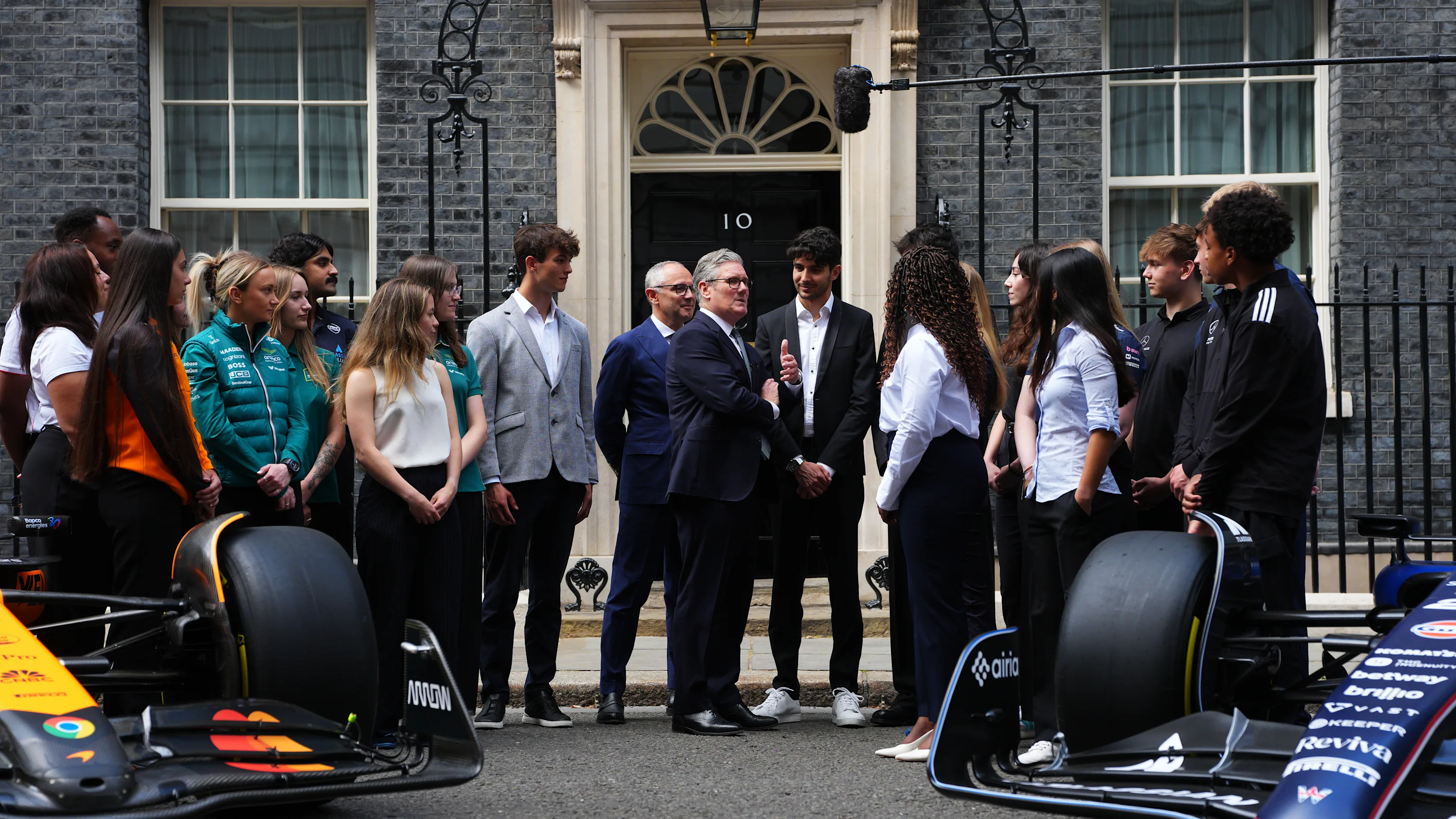 LONDON, ENGLAND - JULY 2: UK Prime Minister talks with Formula One team apprentices outside 10