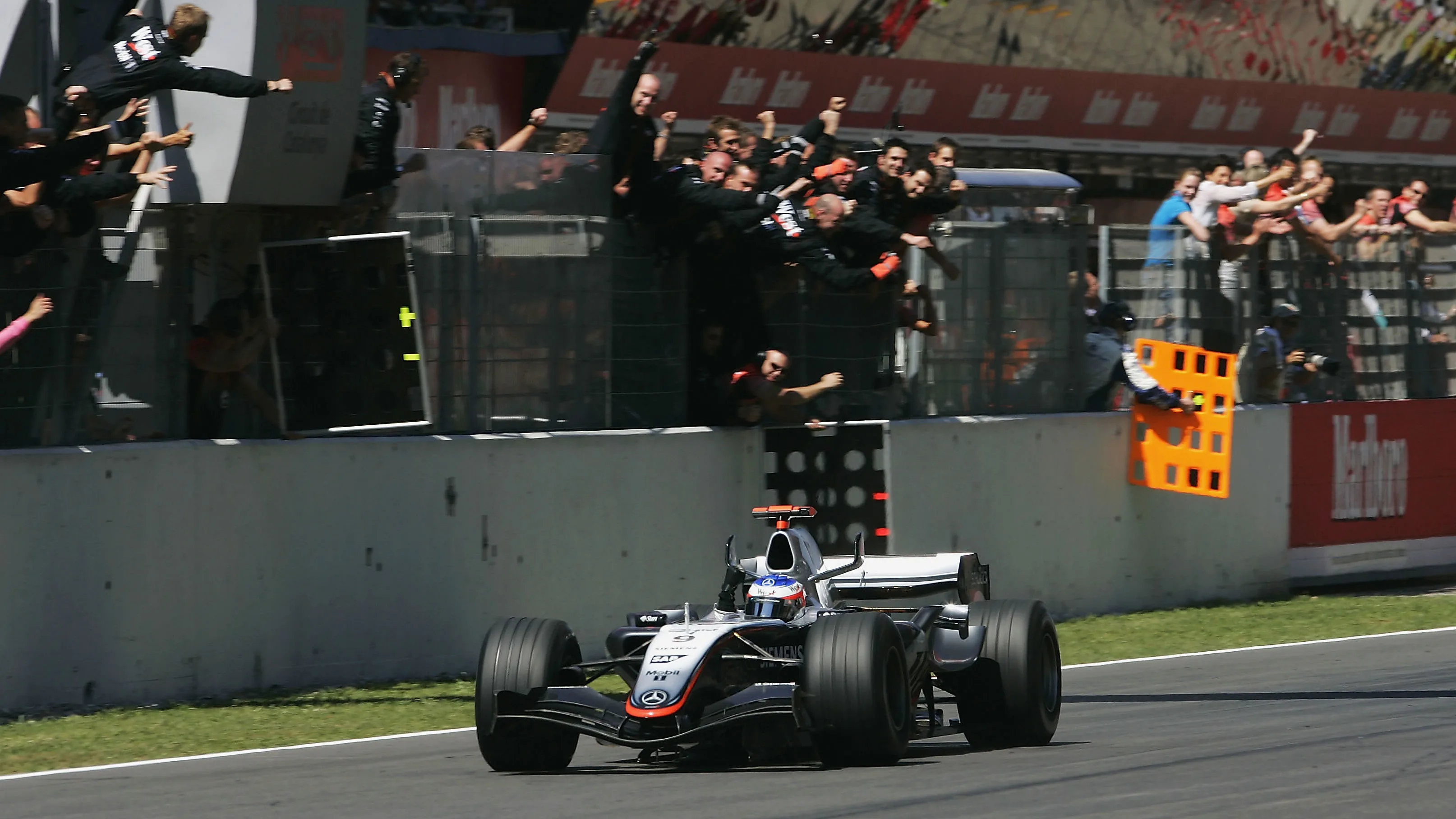 BARCELONA, SPAIN - MAY 8:  Kimi Raikkonen of Finland and McLaren celebrates as he wins the Formula