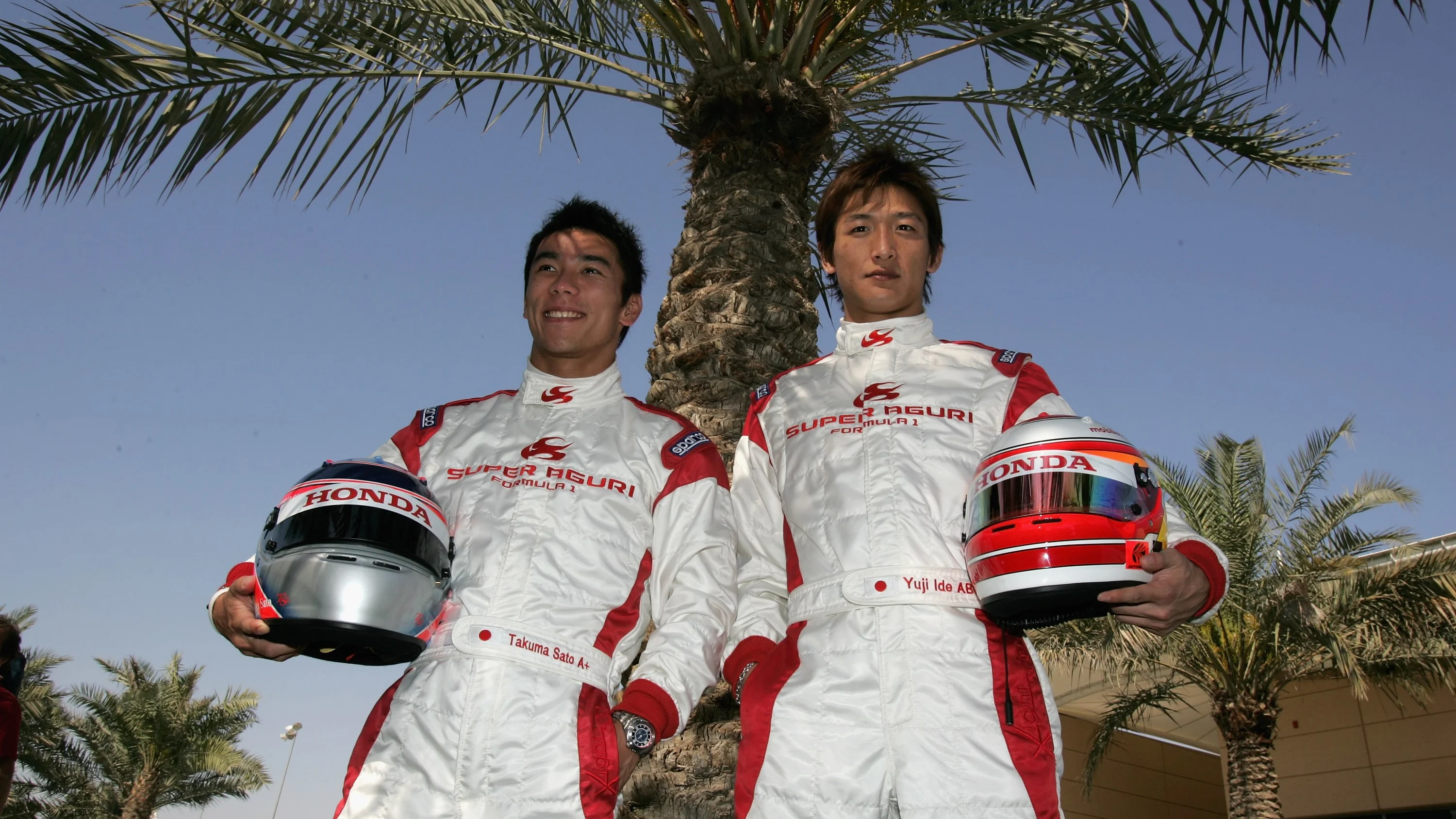 SAKHIR, BAHRAIN - MARCH 09:  Takuma Sato and Yuji Ide of Japan and Super Aguri F1 pose for