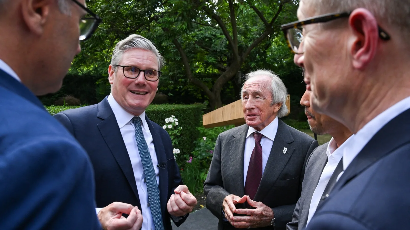 LONDON, ENGLAND - JULY 2: UK Prime Minister talks with Formula One team apprentices outside 10
