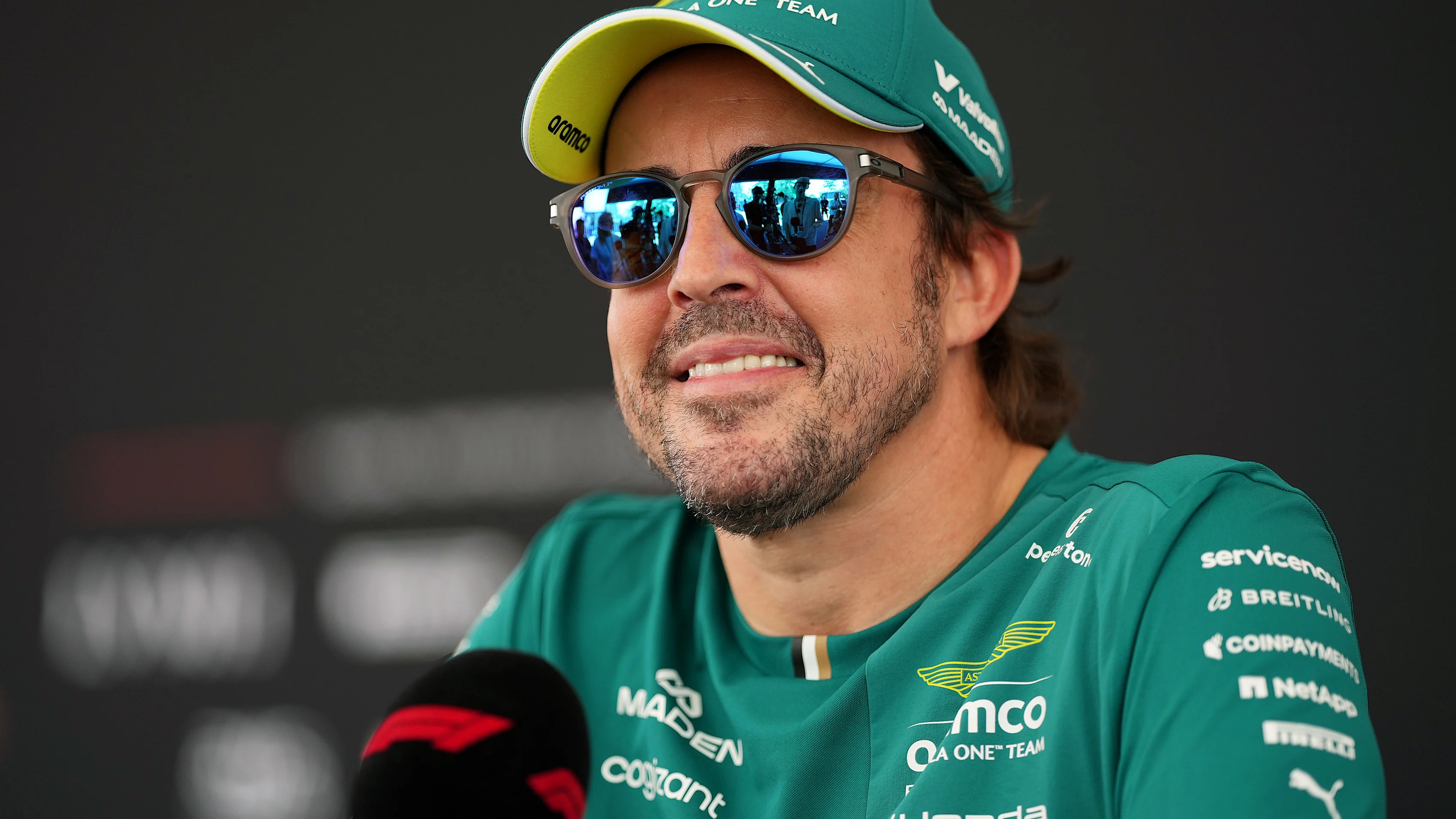 KUALA LUMPUR, MALAYSIA - OCTOBER 01: Fernando Alonso of Spain and Aston Martin F1 Team talks to the