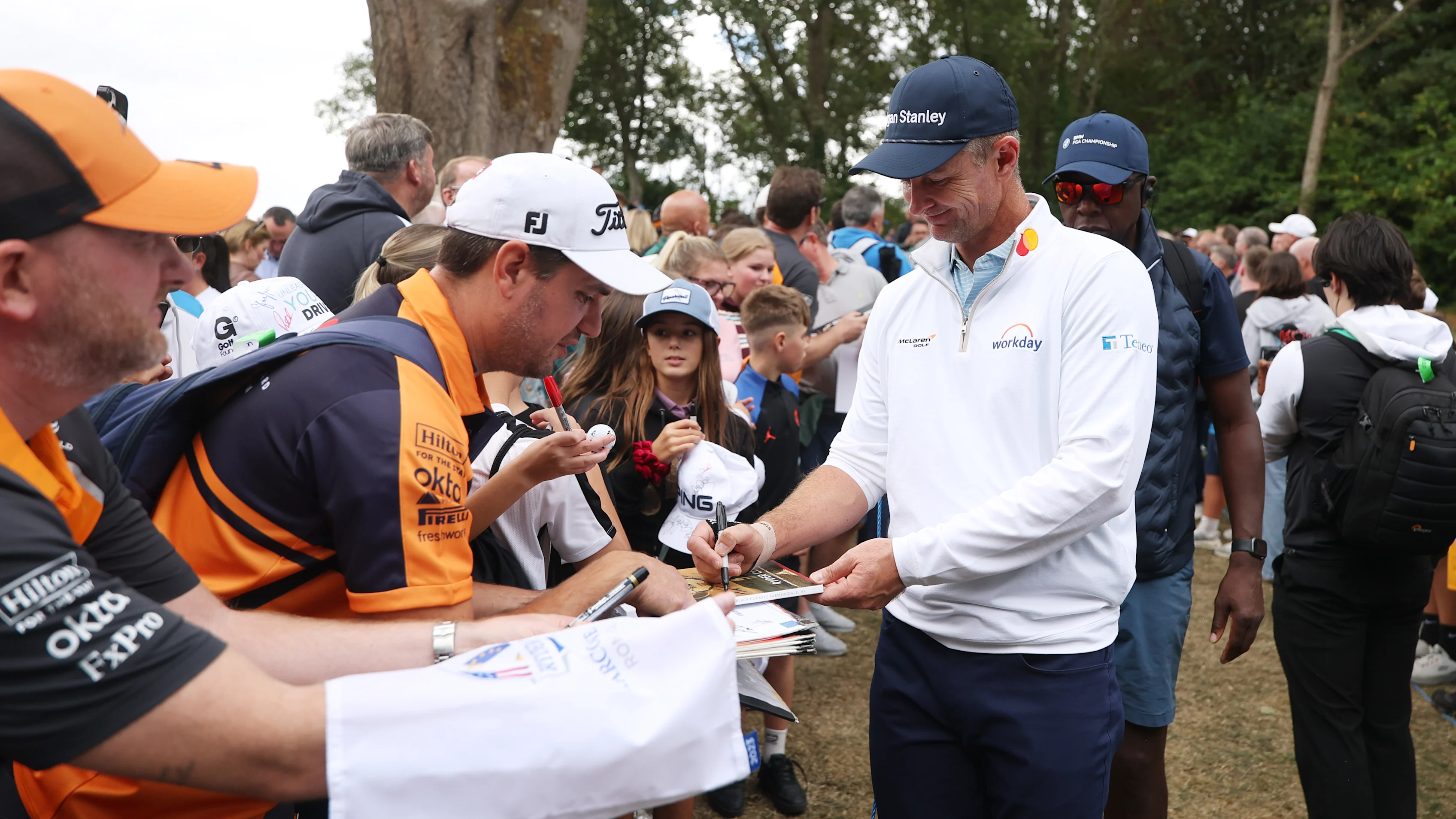 VIRGINIA WATER, ENGLAND - SEPTEMBER 16: Justin Rose of England interacts with fans during the