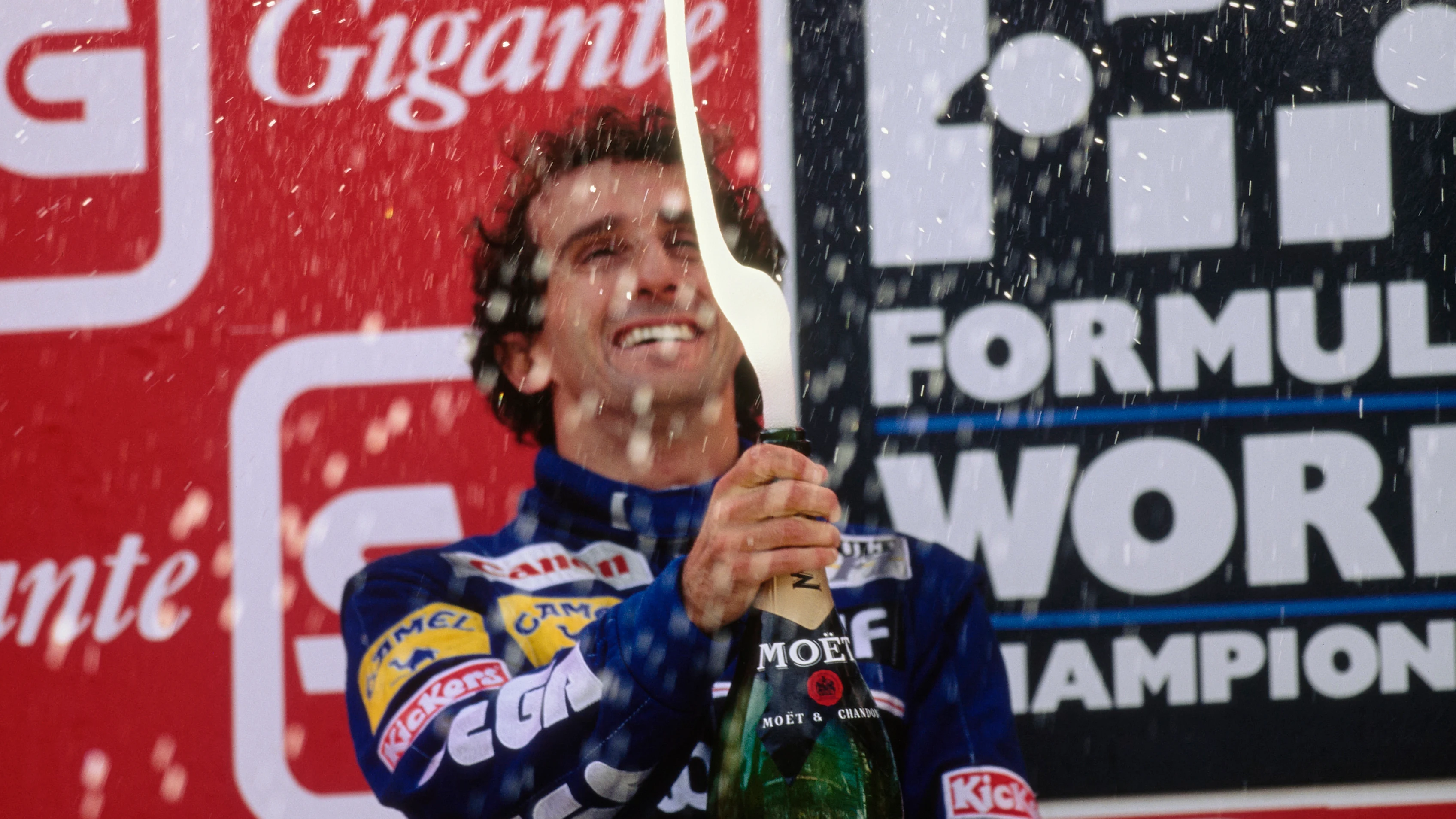 Race winner Alain Prost celebrates securing his fourth World Drivers Championship with Moët et