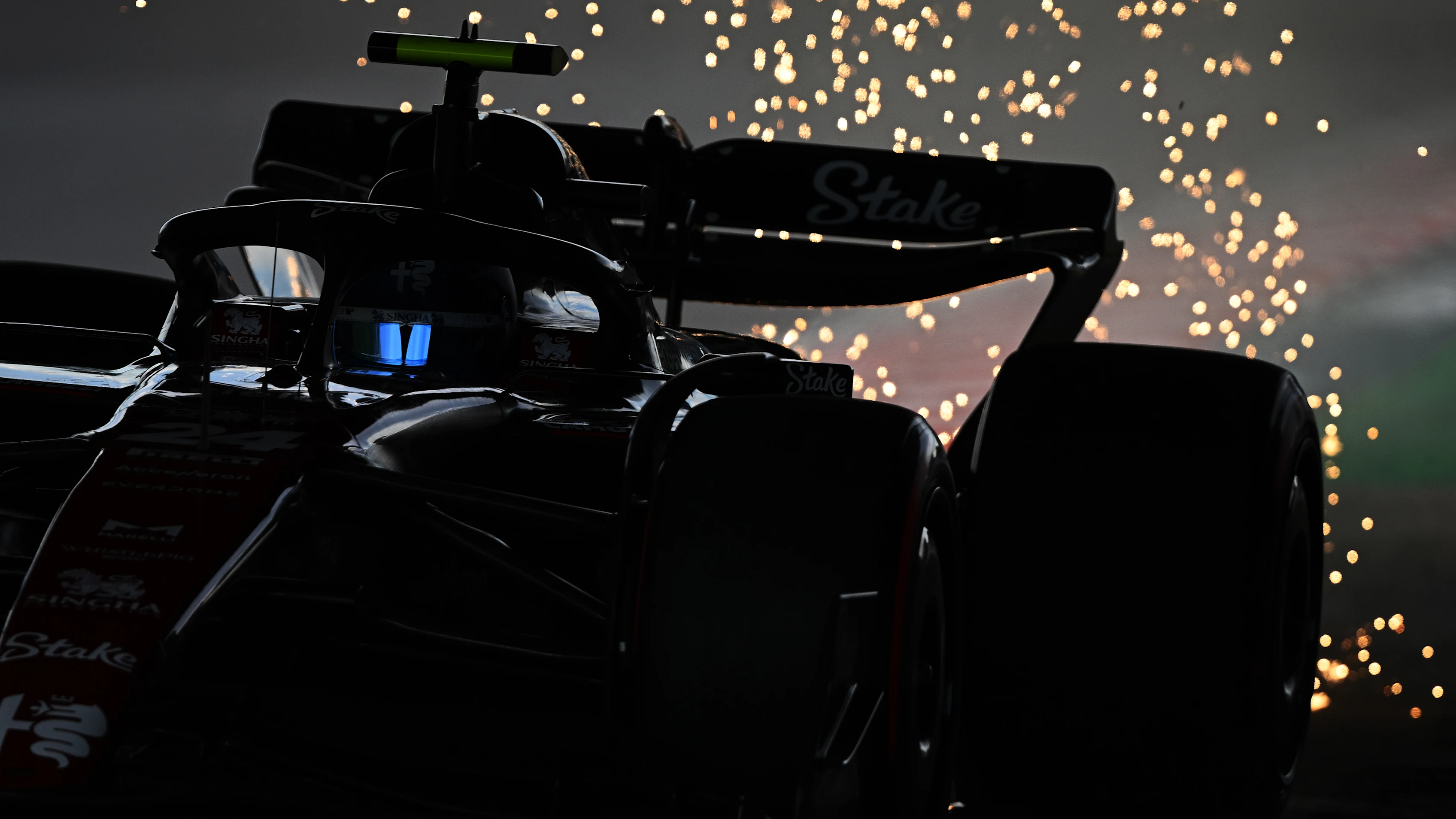 SUZUKA, JAPAN - SEPTEMBER 23: Sparks fly behind Zhou Guanyu of China driving the (24) Alfa Romeo F1