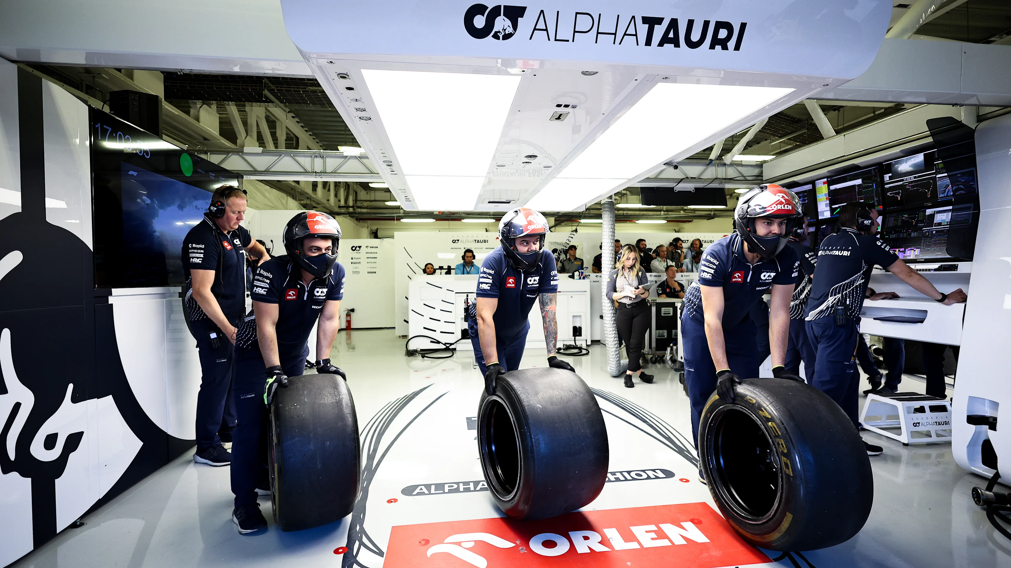 MEXICO CITY, MEXICO - OCTOBER 27: Scuderia AlphaTauri mechanics work in the Pitlane  during