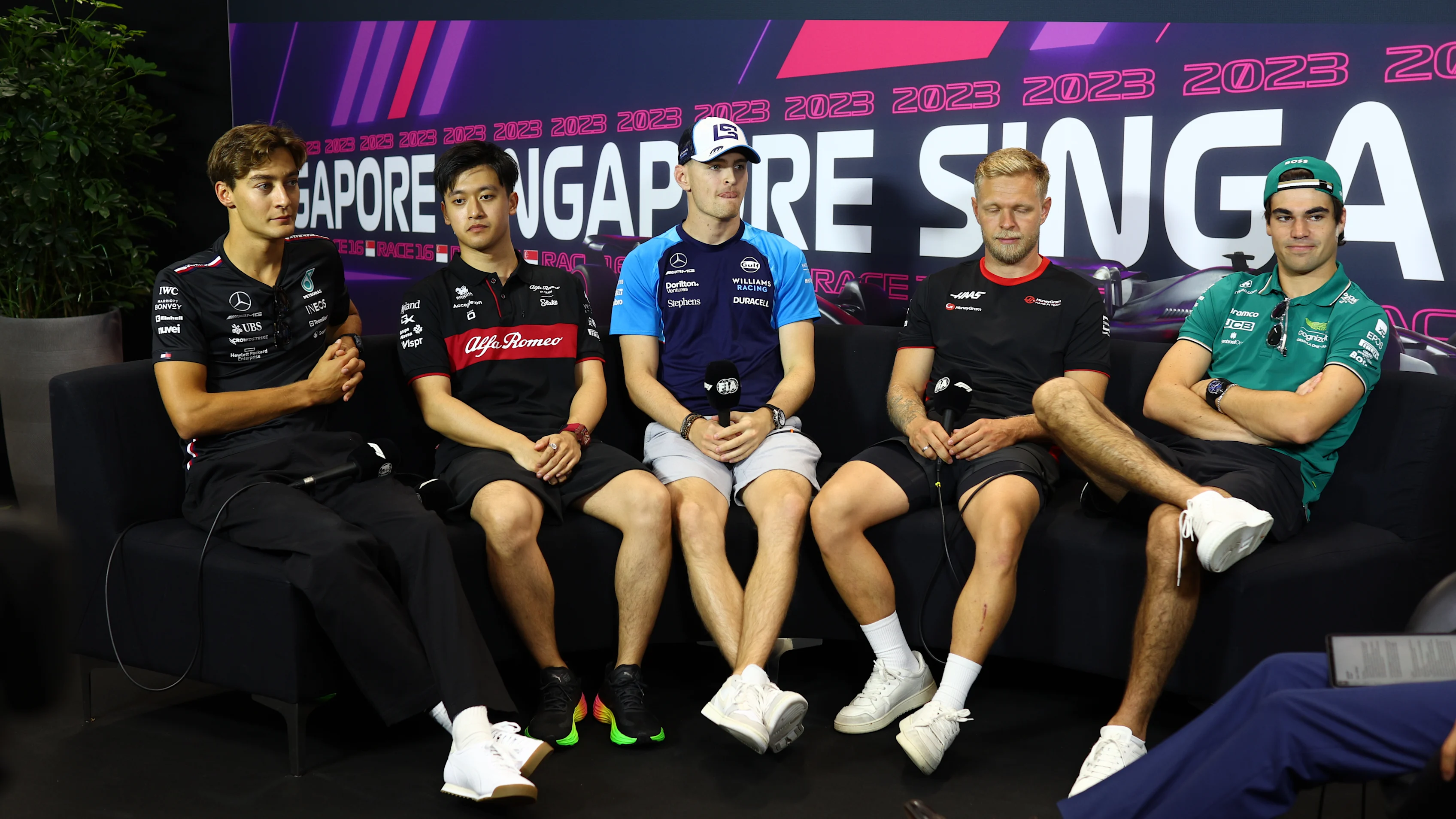 SINGAPORE, SINGAPORE - SEPTEMBER 14: George Russell of Great Britain and Mercedes, Zhou Guanyu of
