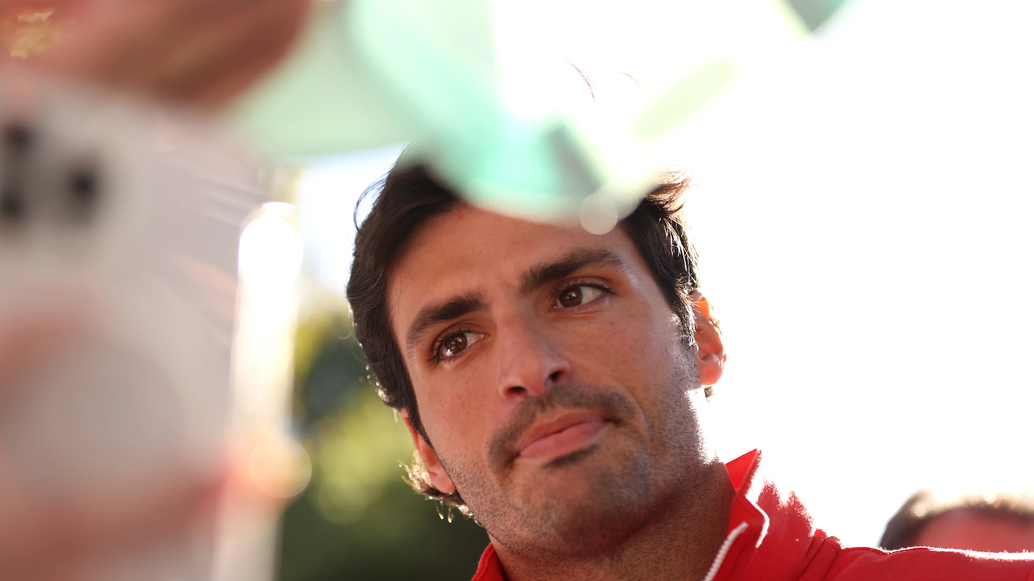 MELBOURNE, AUSTRALIA - MARCH 21: Carlos Sainz of Spain and Ferrari arrives at the circuit during