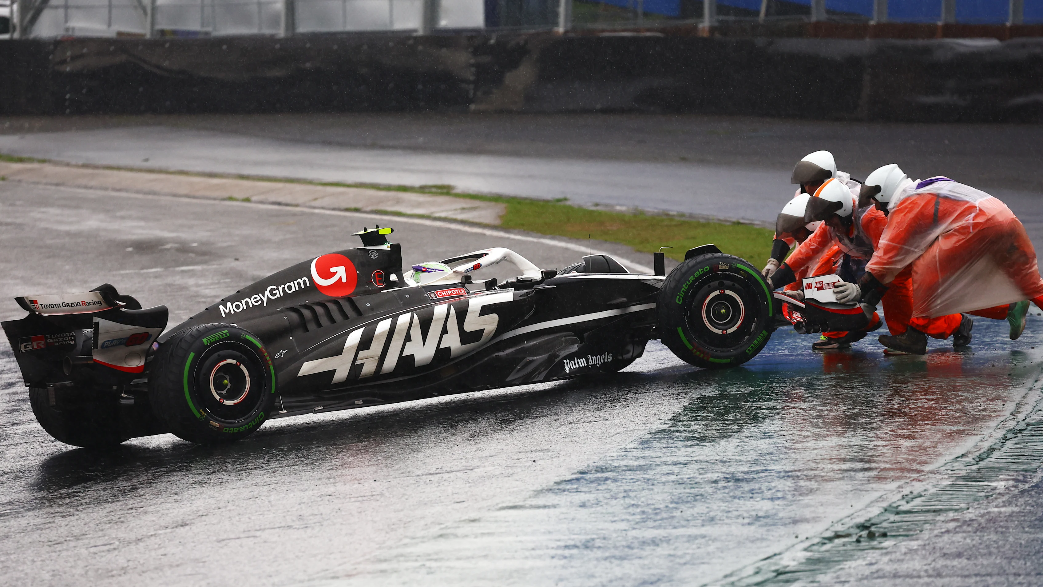 SAO PAULO, BRAZIL - NOVEMBER 03: Marshals push Nico Hulkenberg of Germany driving the (27) Haas F1