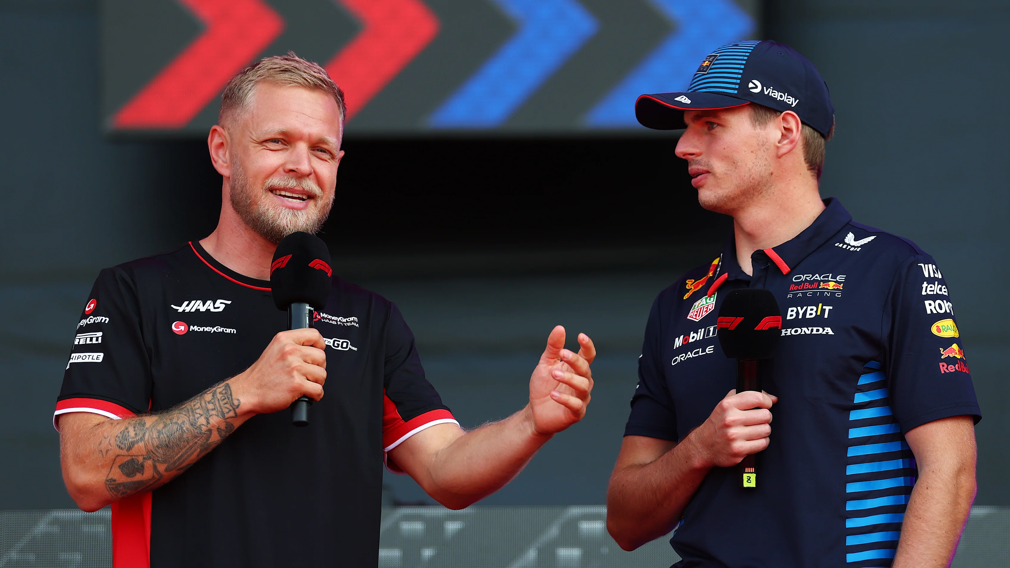 MONZA, ITALY - AUGUST 31: Kevin Magnussen of Denmark and Haas F1 and Max Verstappen of the