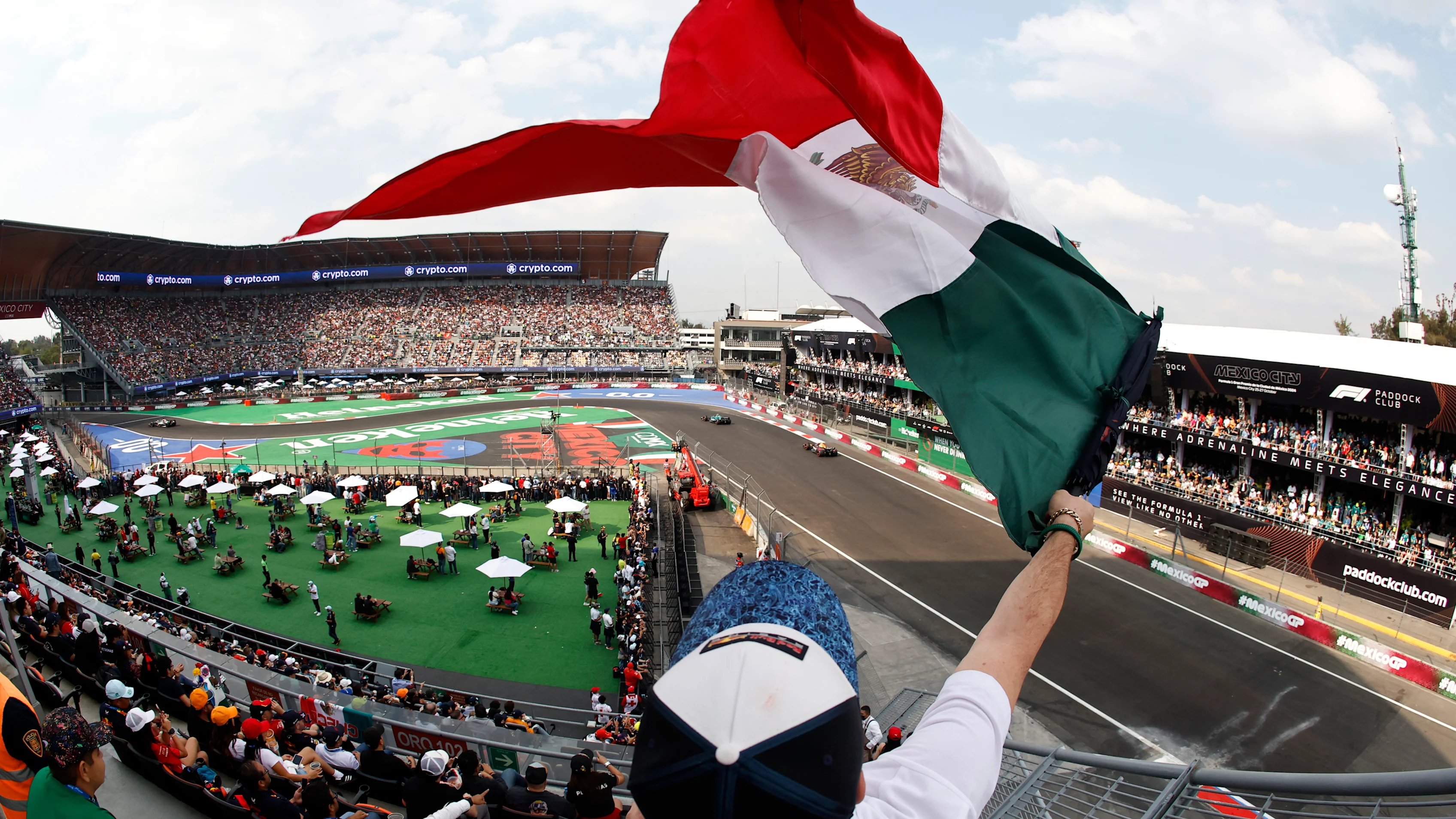 MEXICO CITY, MEXICO - OCTOBER 26: A fan waves a Mexican flag during qualifying ahead of the F1