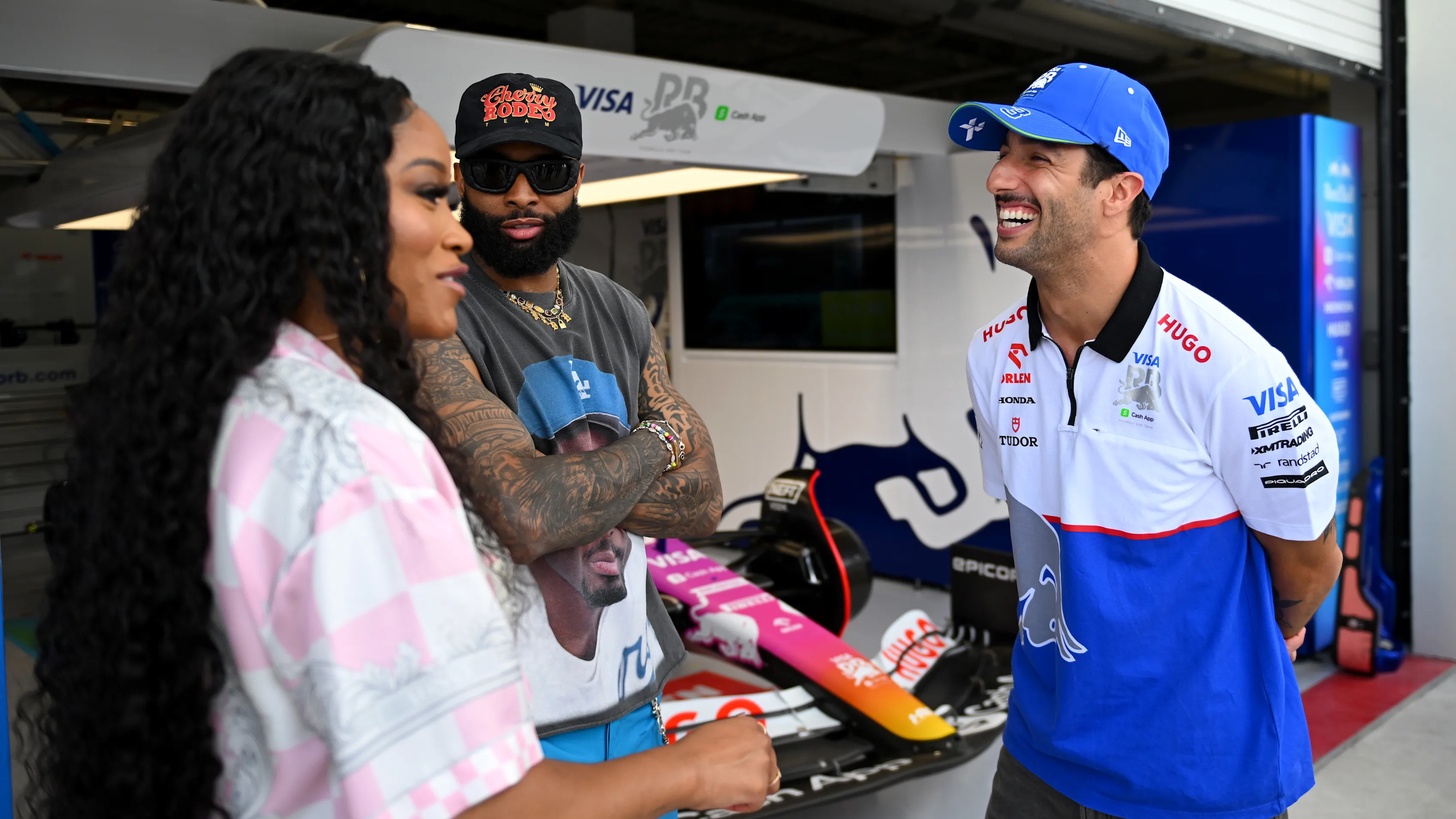 MIAMI, FLORIDA - MAY 05: Odell Beckham Jr and Keke Palmer talks with Daniel Ricciardo of Australia