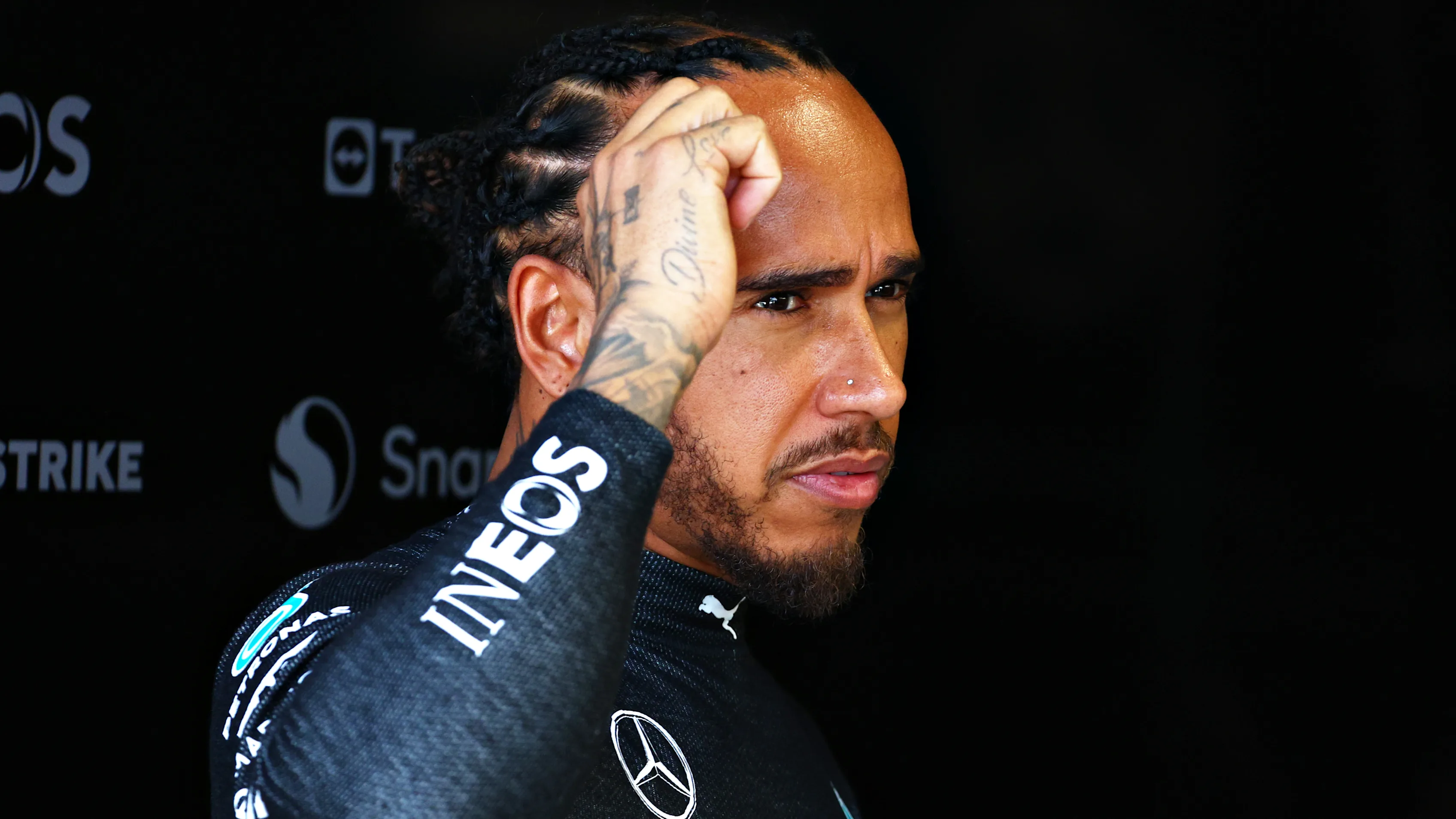 MIAMI, FLORIDA - MAY 03: Lewis Hamilton of Great Britain and Mercedes looks on in the garage prior
