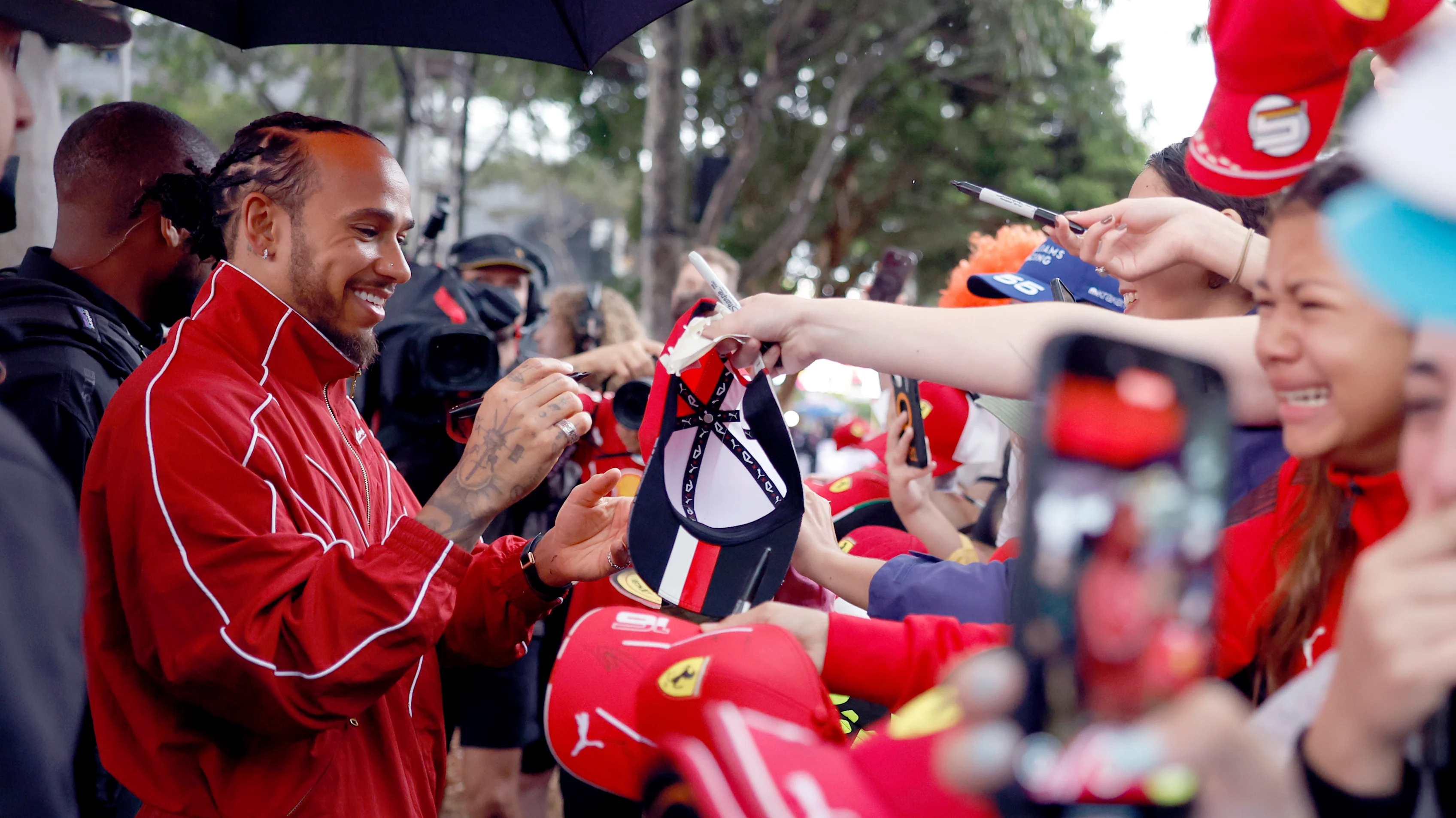 MELBOURNE, AUSTRALIA - MARCH 16: Lewis Hamilton of Great Britain and Scuderia Ferrari signs