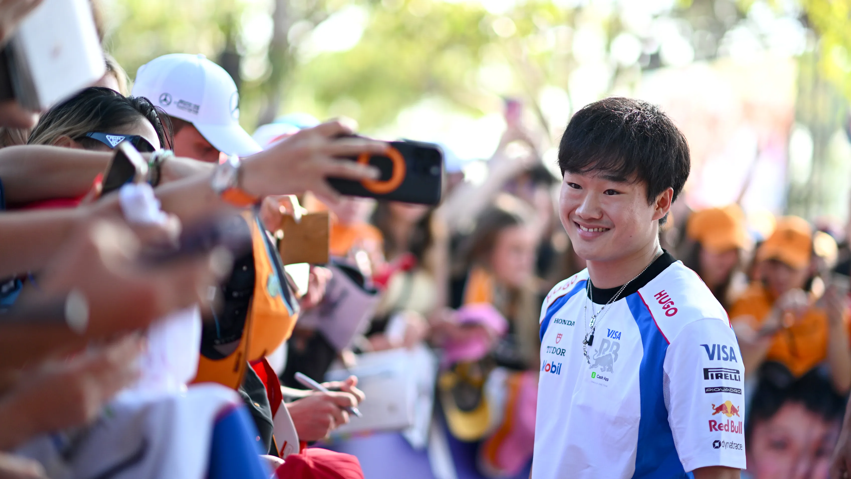 MELBOURNE, AUSTRALIA - MARCH 14: Yuki Tsunoda of Japan and Visa Cash App Racing Bulls meets some