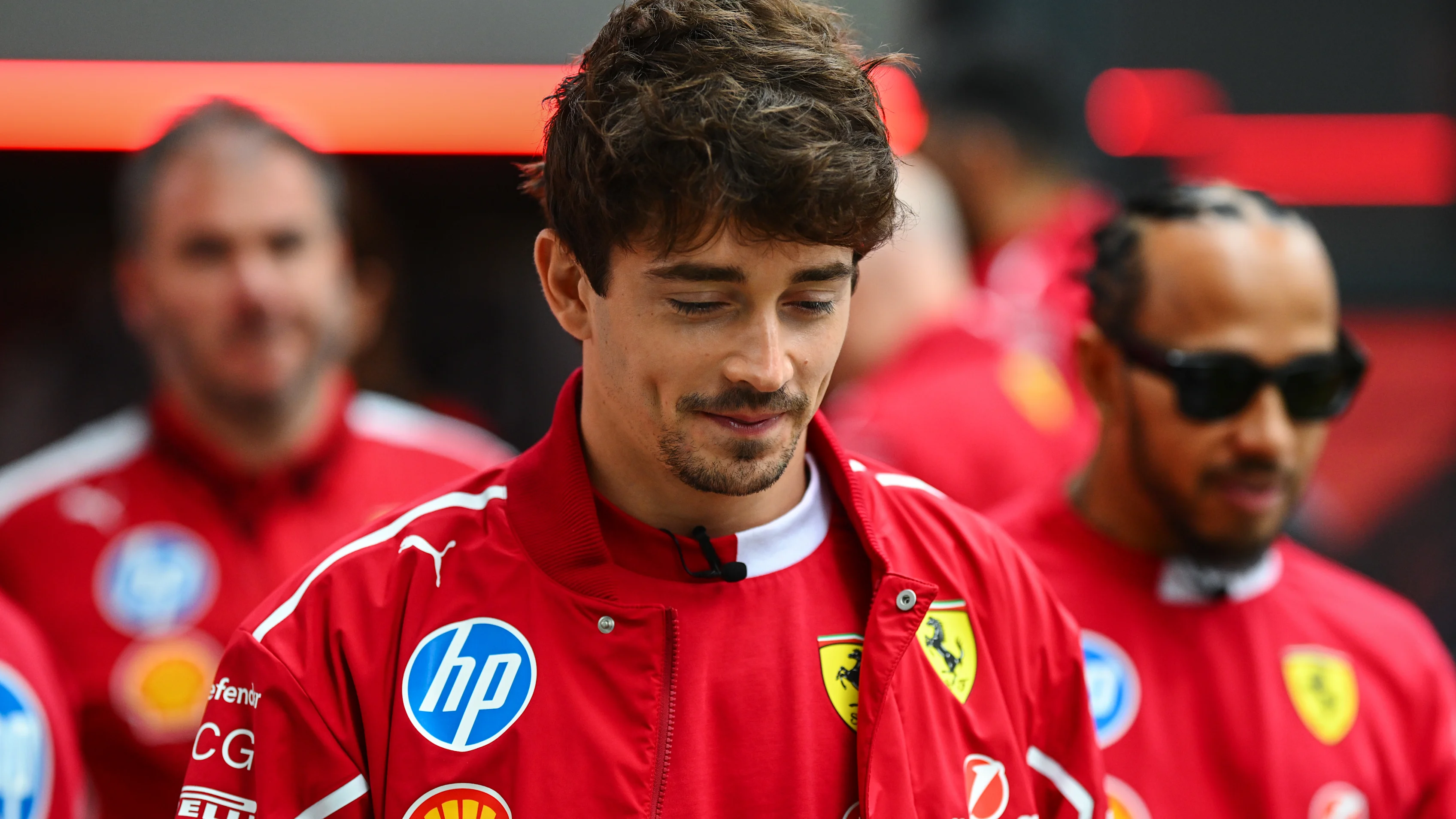 Lewis Hamilton and Charles Leclerc attend the street parade during the Scuderia Ferrari HP Drivers'