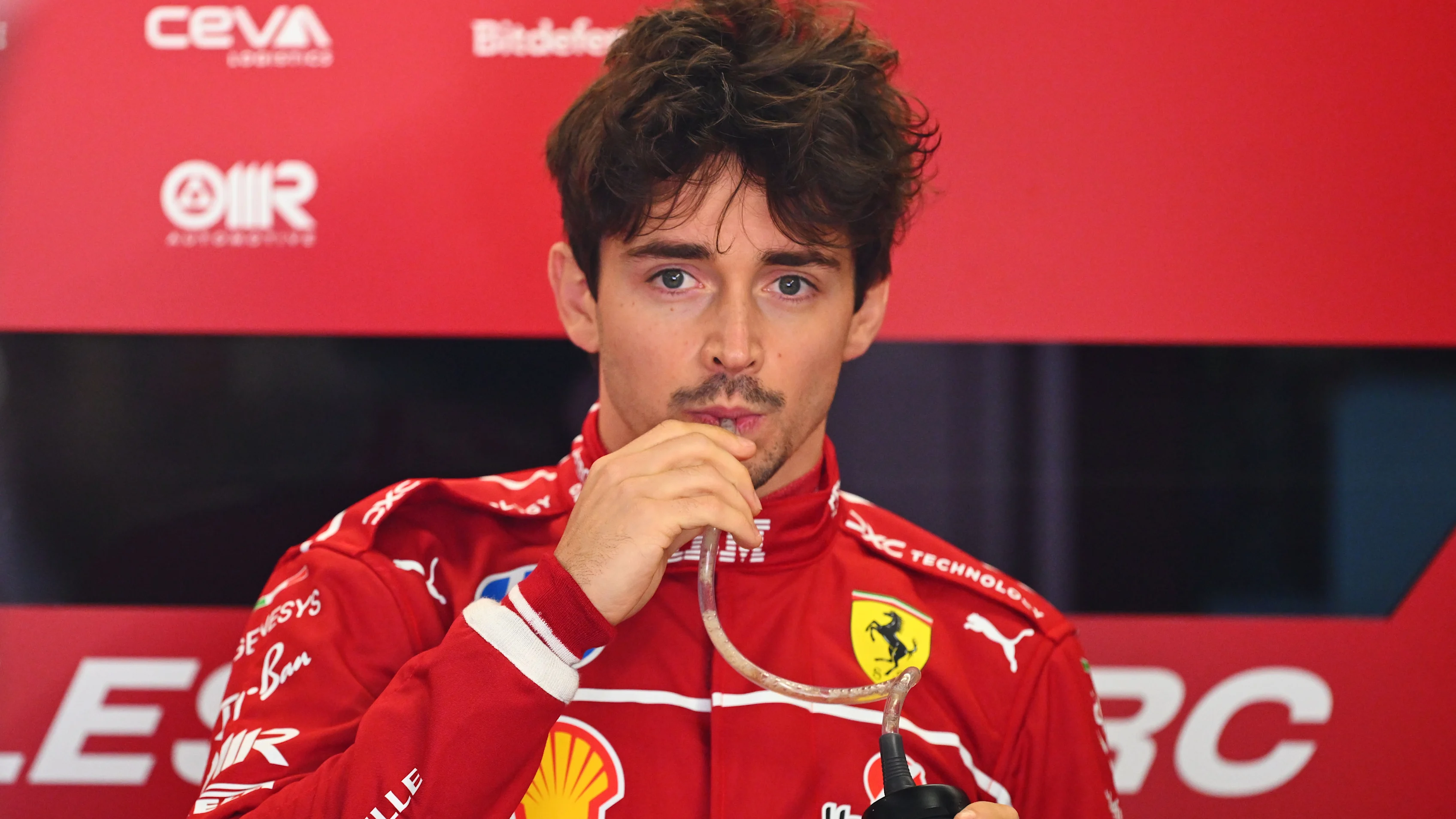 SHANGHAI, CHINA - MARCH 21: Charles Leclerc of Monaco and Scuderia Ferrari looks on in the garage