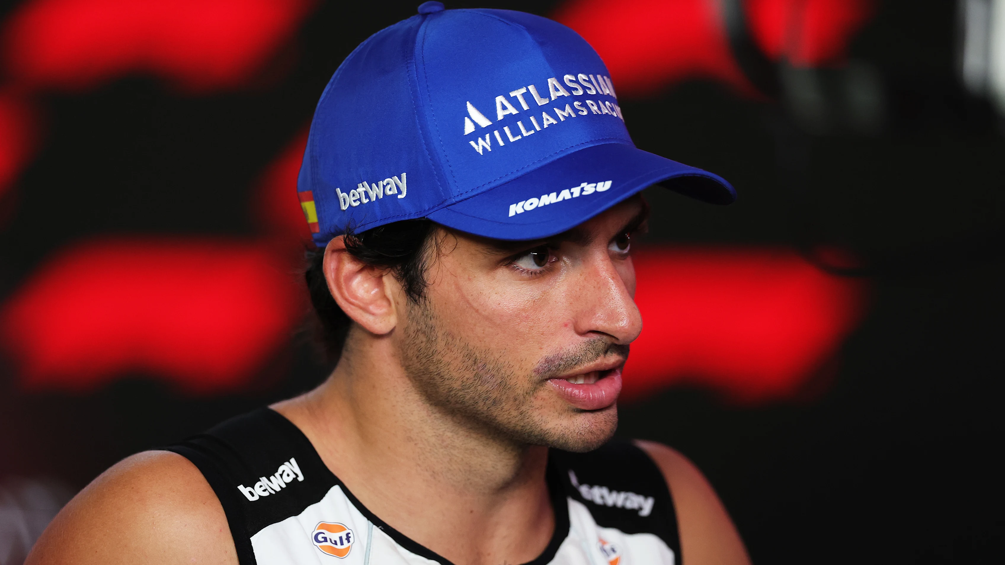 SINGAPORE, SINGAPORE - OCTOBER 05: Tenth placed Carlos Sainz of Spain and Williams talks to the media during the F1 Grand Prix of Singapore at Marina Bay Street Circuit on October 05, 2025 in Singapore, Singapore. (Photo by Bryn Lennon/Getty Images)