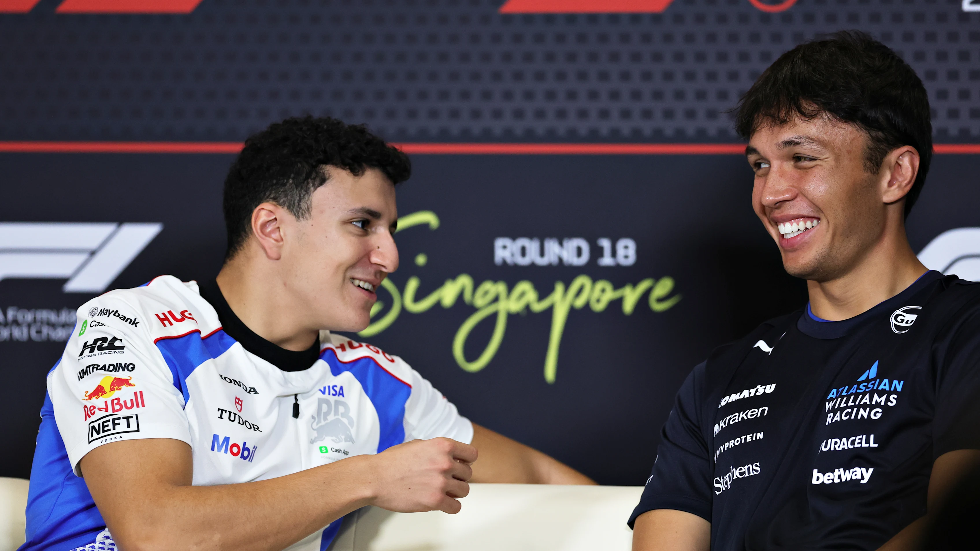 SINGAPORE, SINGAPORE - OCTOBER 02: Isack Hadjar of France and Visa Cash App Racing Bulls talks with Alexander Albon of Thailand and Williams in the Drivers Press Conference during previews ahead of the F1 Grand Prix of Singapore at Marina Bay Street Circuit on October 02, 2025 in Singapore, Singapore. (Photo by Bryn Lennon/Getty Images)