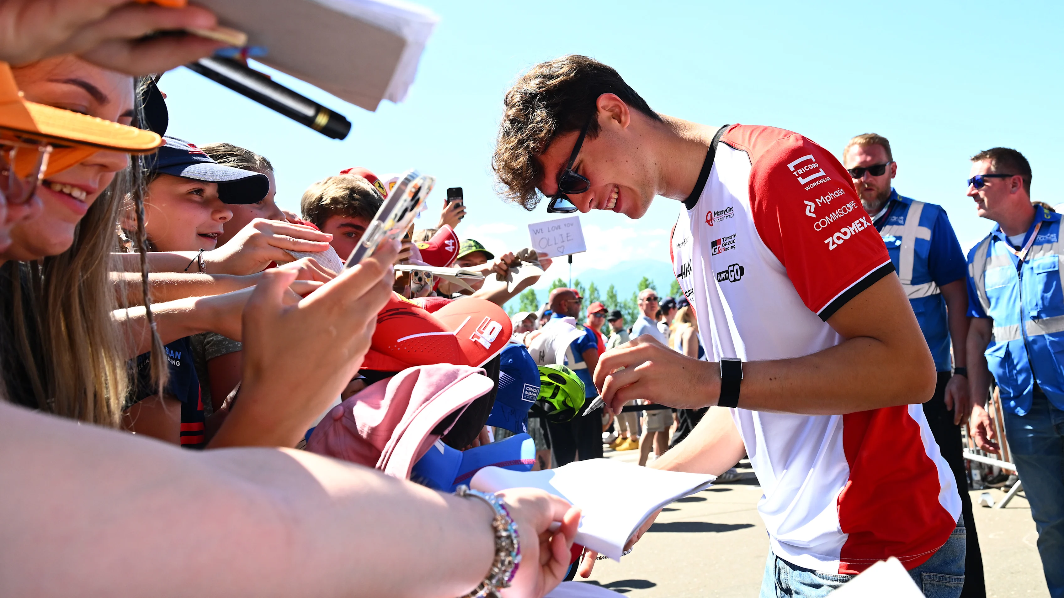 SPIELBERG, AUSTRIA - JUNE 29: Oliver Bearman of Great Britain and Haas F1 signs autographs for fans