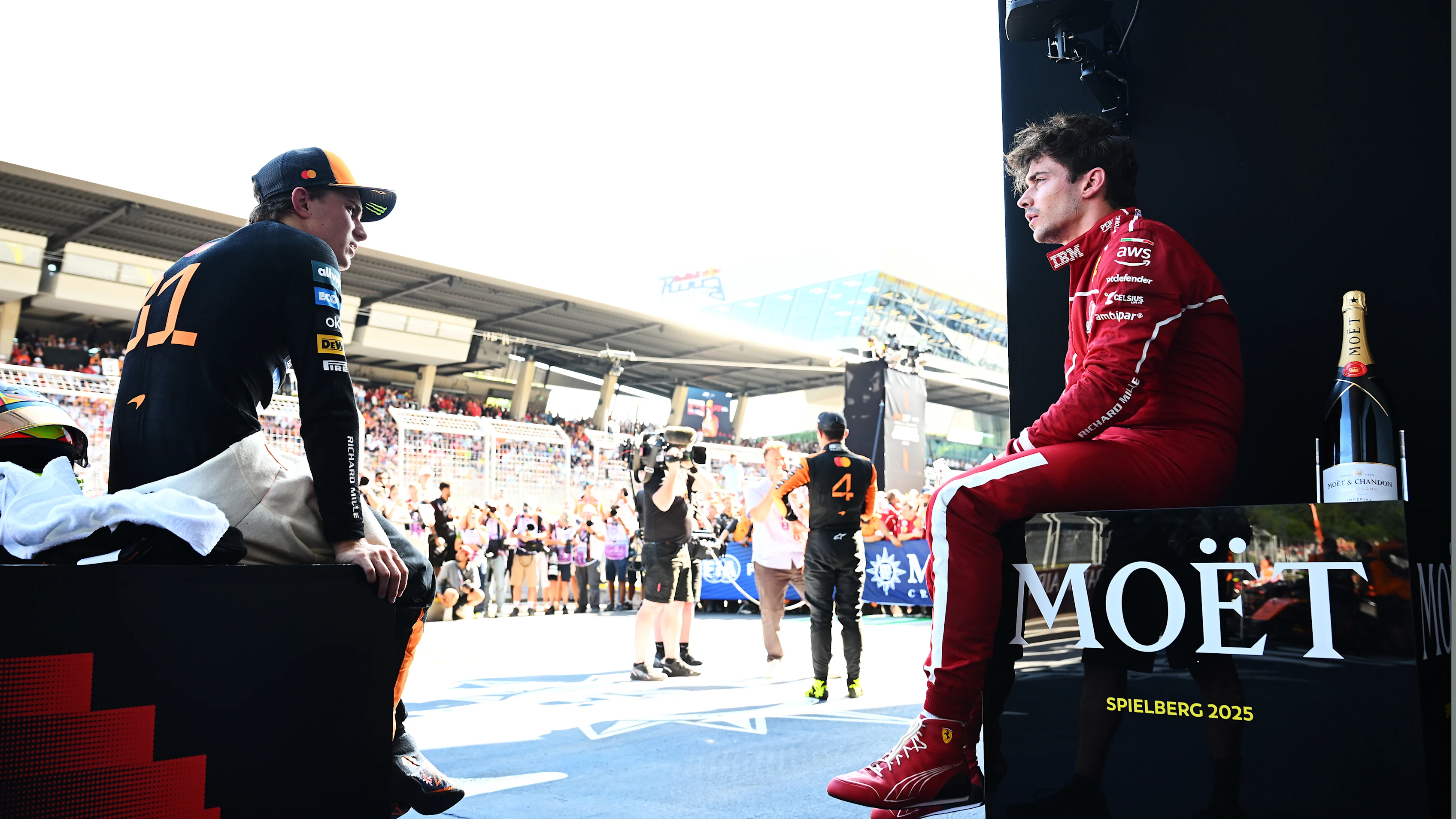 SPIELBERG, AUSTRIA - JUNE 29: Second placed Oscar Piastri of Australia and McLaren and Third placed Charles Leclerc of Monaco and Scuderia Ferrari in parc ferme during the F1 Grand Prix of Austria at Red Bull Ring on June 29, 2025 in Spielberg, Austria. (Photo by Mark Sutton - Formula 1/Formula 1 via Getty Images)