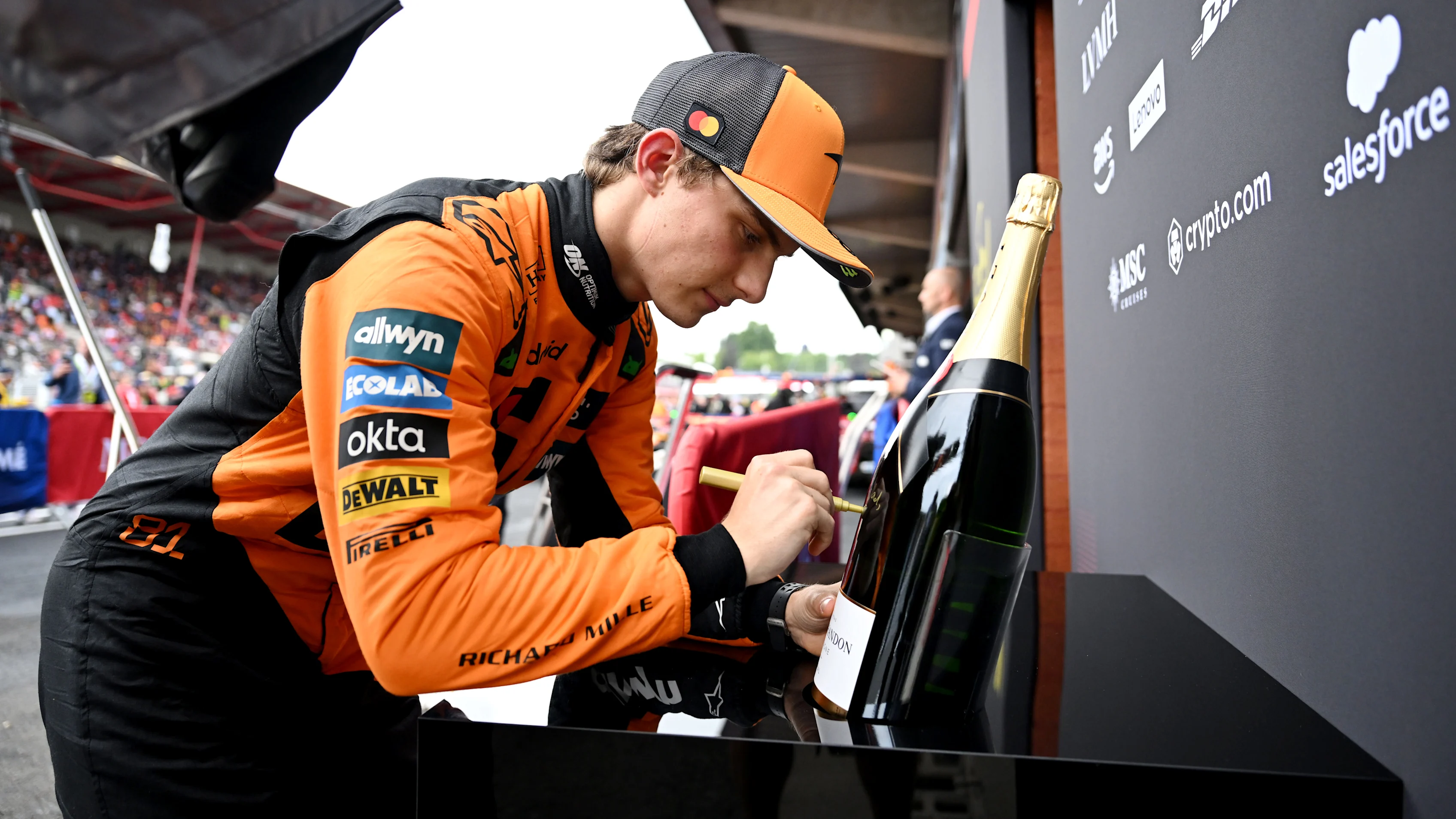 SPA, BELGIUM - JULY 27: Race winner Oscar Piastri of Australia and McLaren signs a Champagne bottle