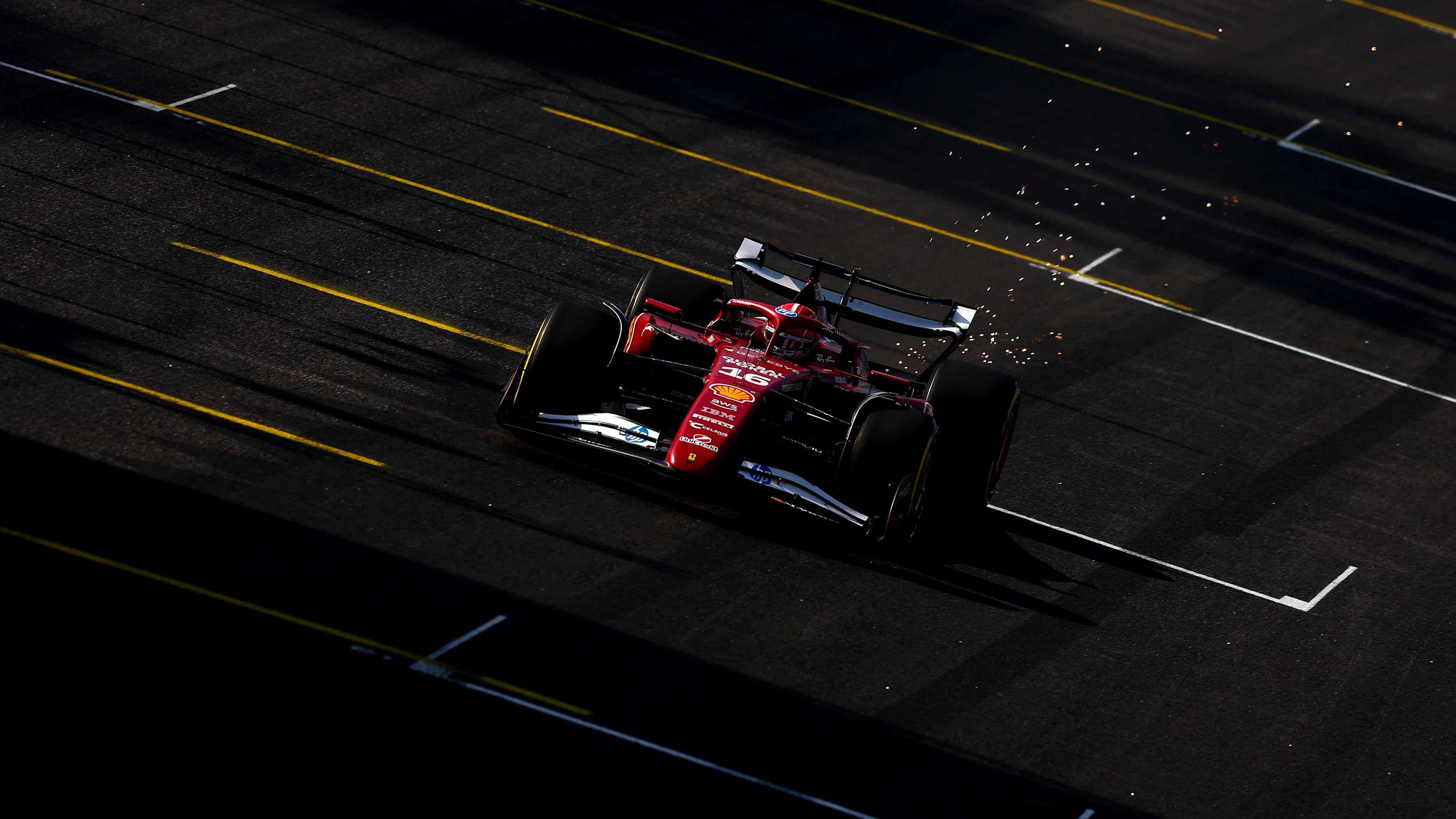 SAO PAULO, BRAZIL - NOVEMBER 07: Sparks fly behind Charles Leclerc of Monaco driving the (16) Scuderia Ferrari SF-25 on track during Sprint Qualifying ahead of the F1 Grand Prix of Brazil at Autodromo Jose Carlos Pace on November 07, 2025 in Sao Paulo, Brazil. (Photo by Mark Thompson/Getty Images)