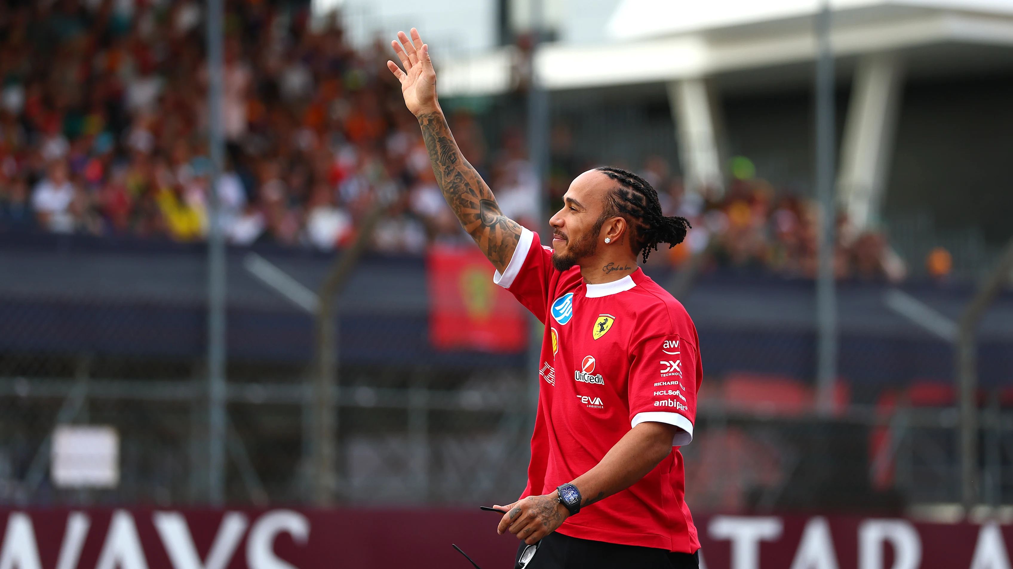NORTHAMPTON, ENGLAND - JULY 03: Lewis Hamilton of Great Britain and Scuderia Ferrari waves to fans