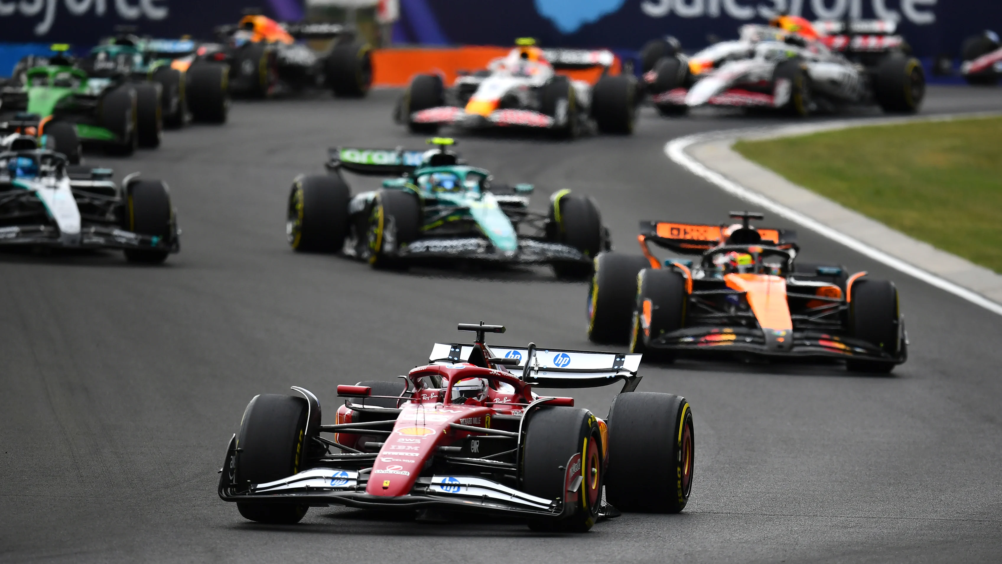 BUDAPEST, HUNGARY - AUGUST 03: Charles Leclerc of Monaco driving the (16) Scuderia Ferrari SF-25 leads Oscar Piastri of Australia driving the (81) McLaren MCL39 Mercedes and Fernando Alonso of Spain driving the (14) Aston Martin F1 Team AMR25 Mercedes at the start during the F1 Grand Prix of Hungary at Hungaroring on August 03, 2025 in Budapest, Hungary. (Photo by James Sutton - Formula 1/Formula 1 via Getty Images)