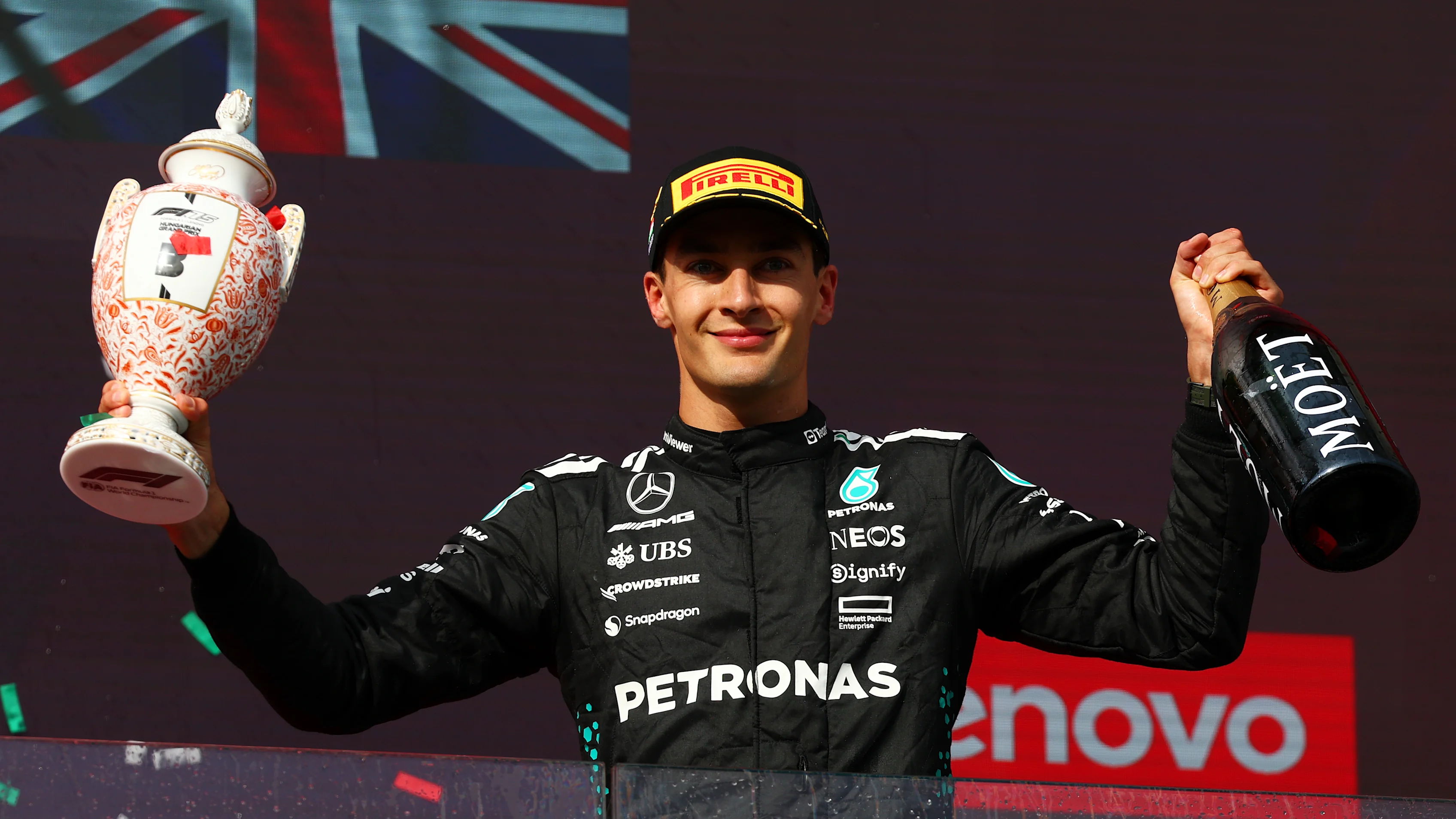 BUDAPEST, HUNGARY - AUGUST 03: Third placed George Russell of Great Britain and Mercedes AMG Petronas F1 Team on the podium with his trophy and Champagne during the F1 Grand Prix of Hungary at Hungaroring on August 03, 2025 in Budapest, Hungary. (Photo by Clive Rose/Getty Images)