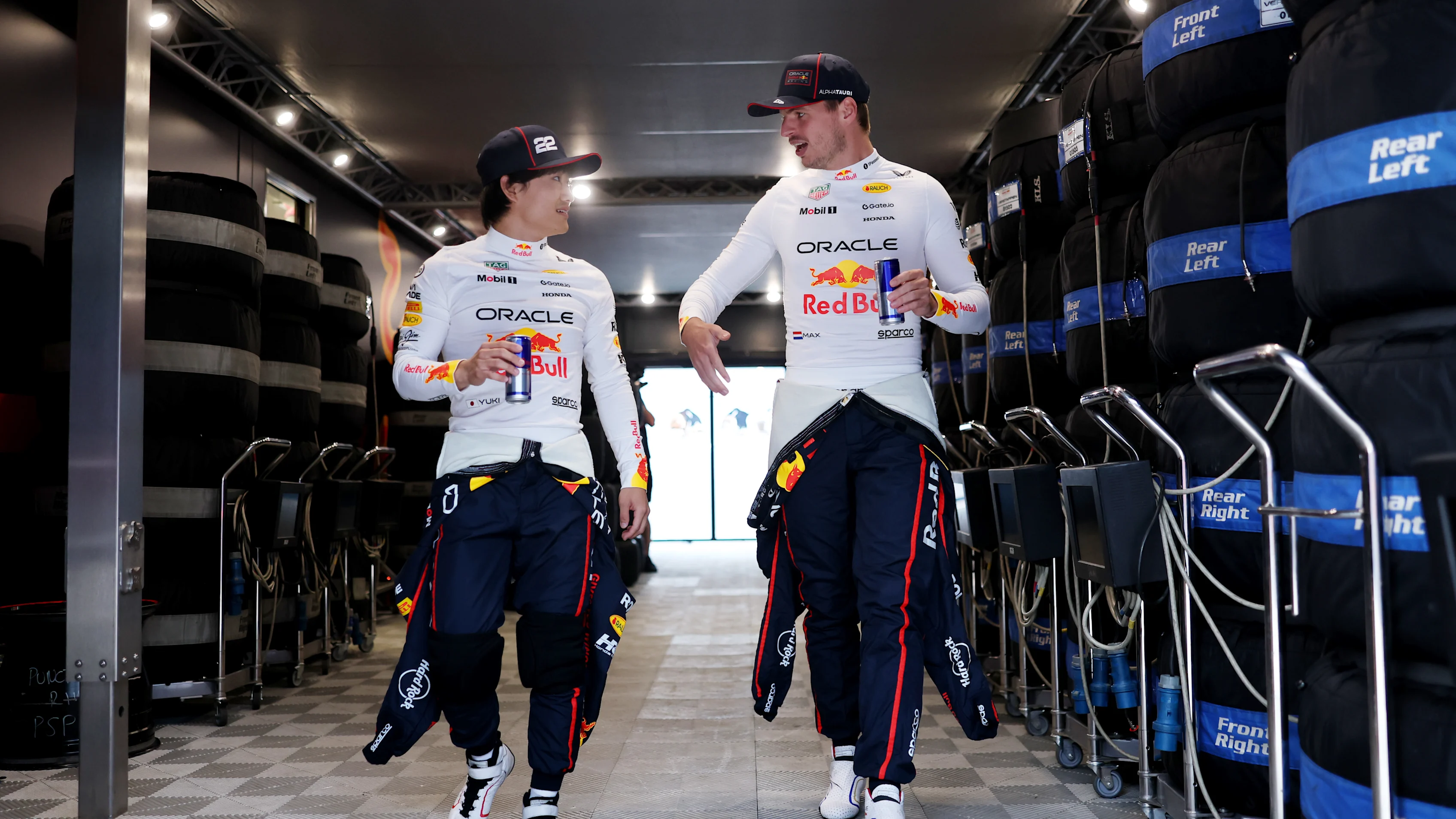 BUDAPEST, HUNGARY - AUGUST 01: Yuki Tsunoda of Japan and Oracle Red Bull Racing talks with Max