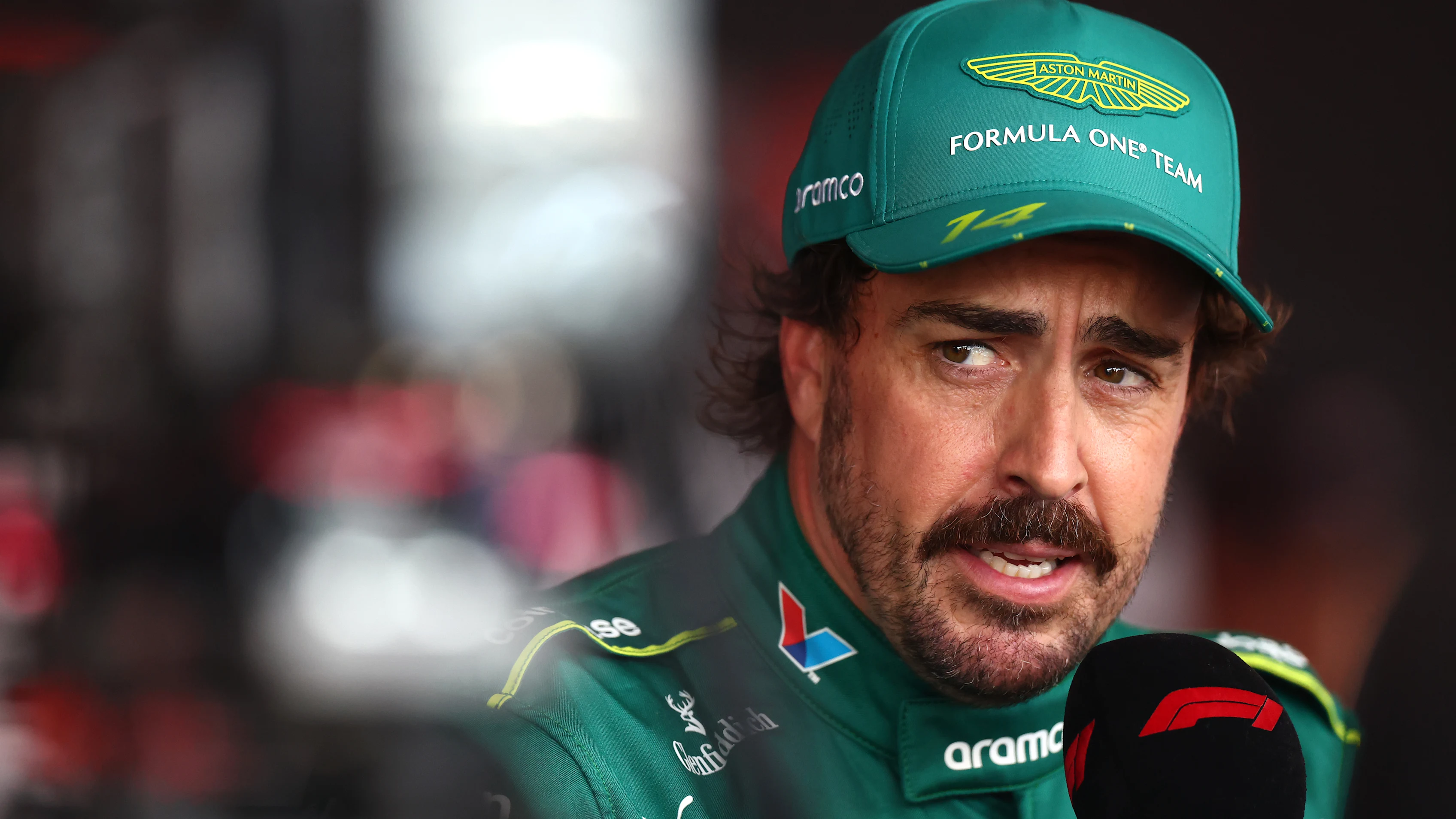 BUDAPEST, HUNGARY - AUGUST 01: Fernando Alonso of Spain and Aston Martin F1 Team is interviewed during practice ahead of the F1 Grand Prix of Hungary at Hungaroring on August 01, 2025 in Budapest, Hungary. (Photo by Bryn Lennon - Formula 1/Formula 1 via Getty Images)