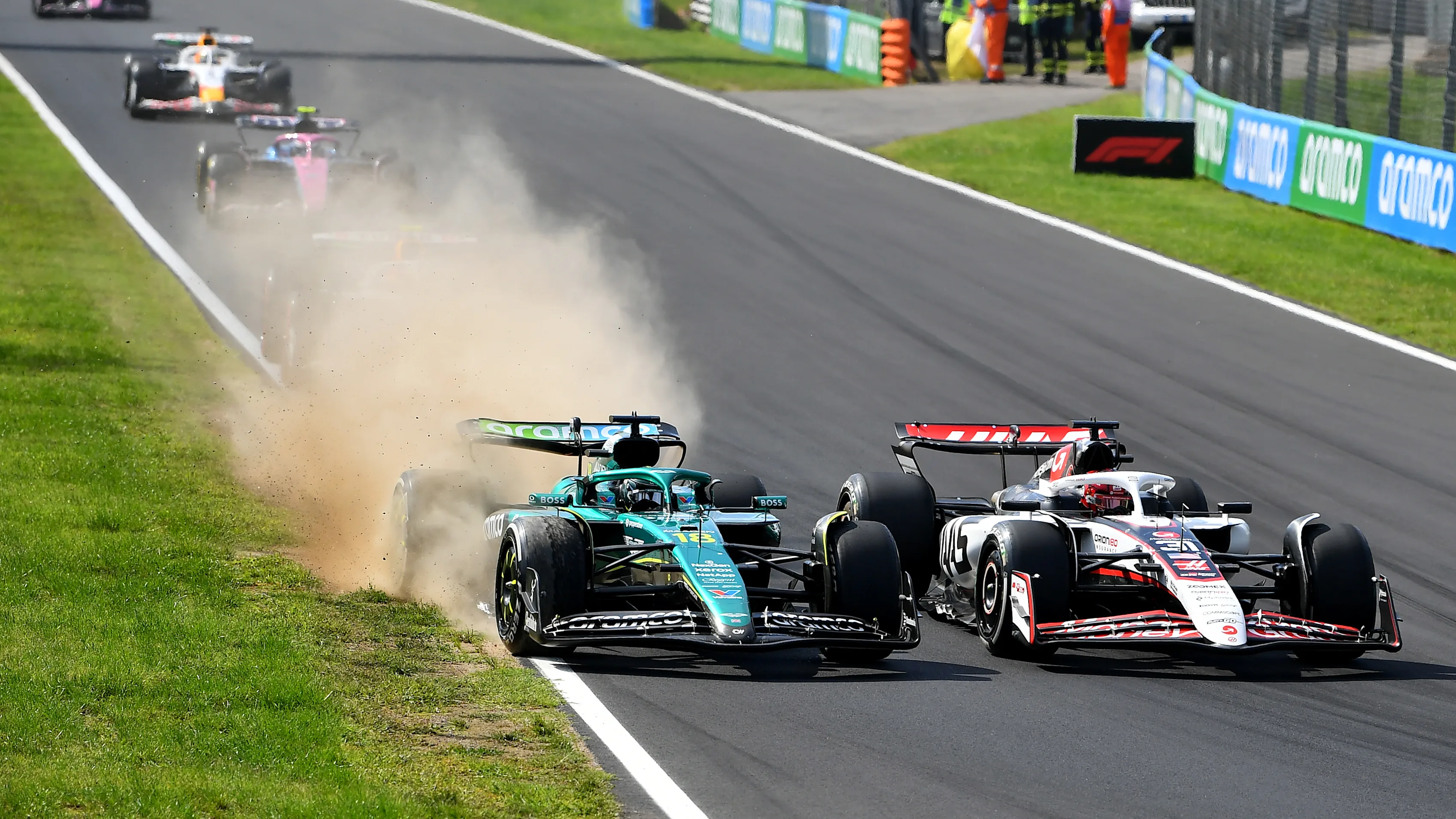 MONZA, ITALY - SEPTEMBER 07: Lance Stroll of Canada driving the (18) Aston Martin F1 Team AMR25 Mercedes and Esteban Ocon of France driving the (31) Haas F1 VF-25 Ferrari battle for track position during the F1 Grand Prix of Italy at Autodromo Nazionale Monza on September 07, 2025 in Monza, Italy. (Photo by James Sutton - Formula 1/Formula 1 via Getty Images)