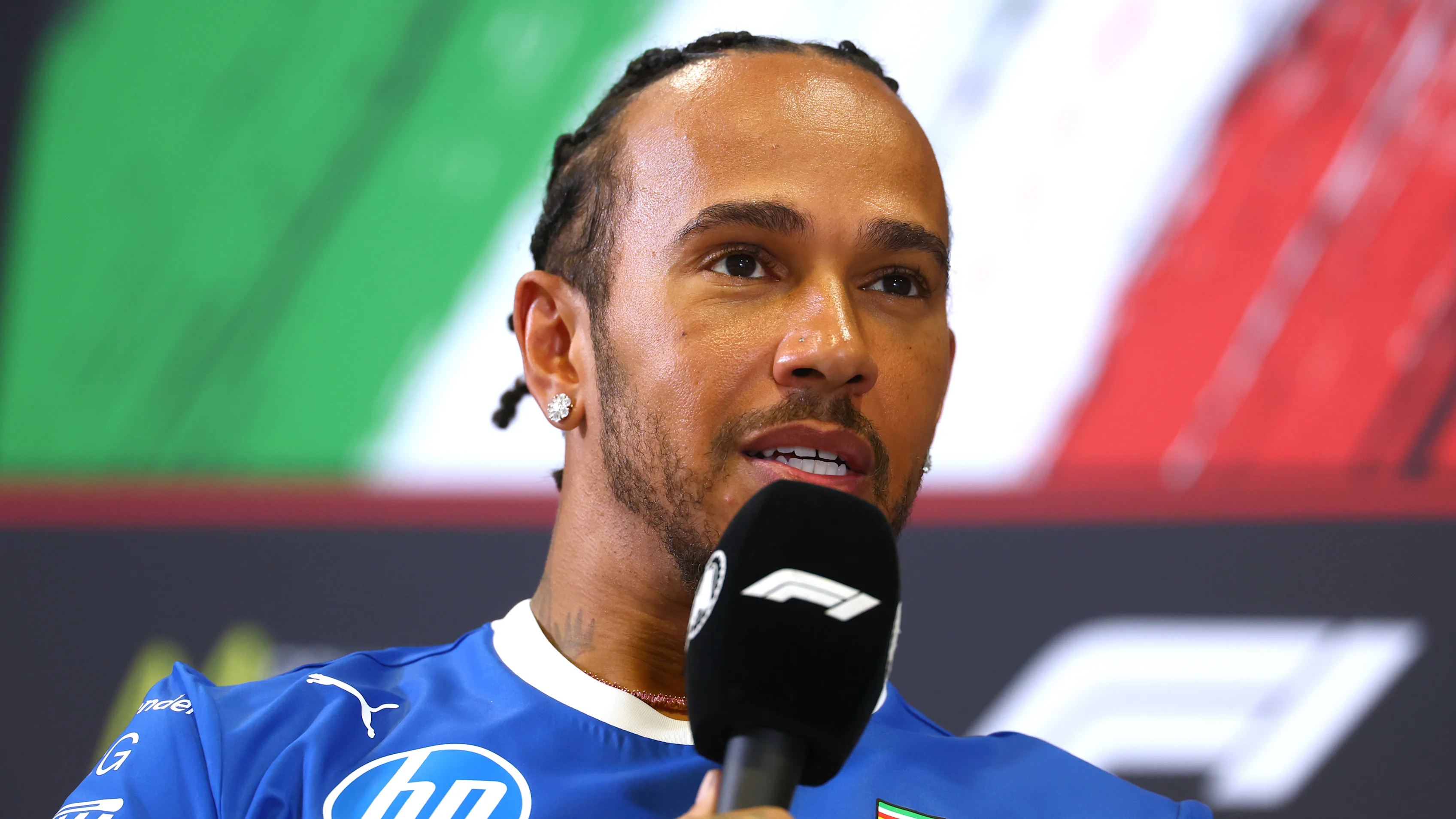 MONZA, ITALY - SEPTEMBER 04: Lewis Hamilton of Great Britain and Scuderia Ferrari speaks in the