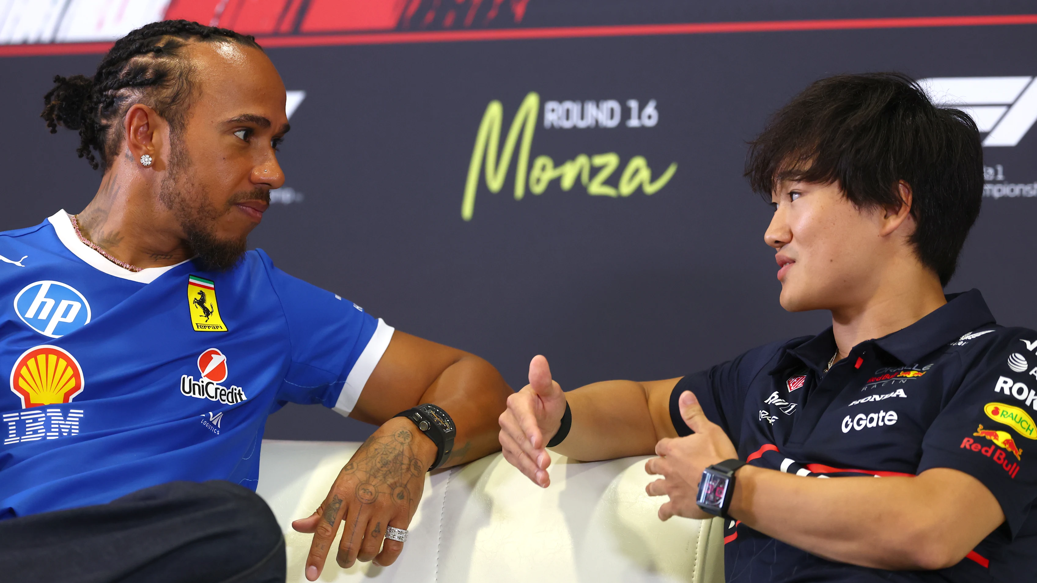 MONZA, ITALY - SEPTEMBER 04: Lewis Hamilton of Great Britain and Scuderia Ferrari talks with Yuki