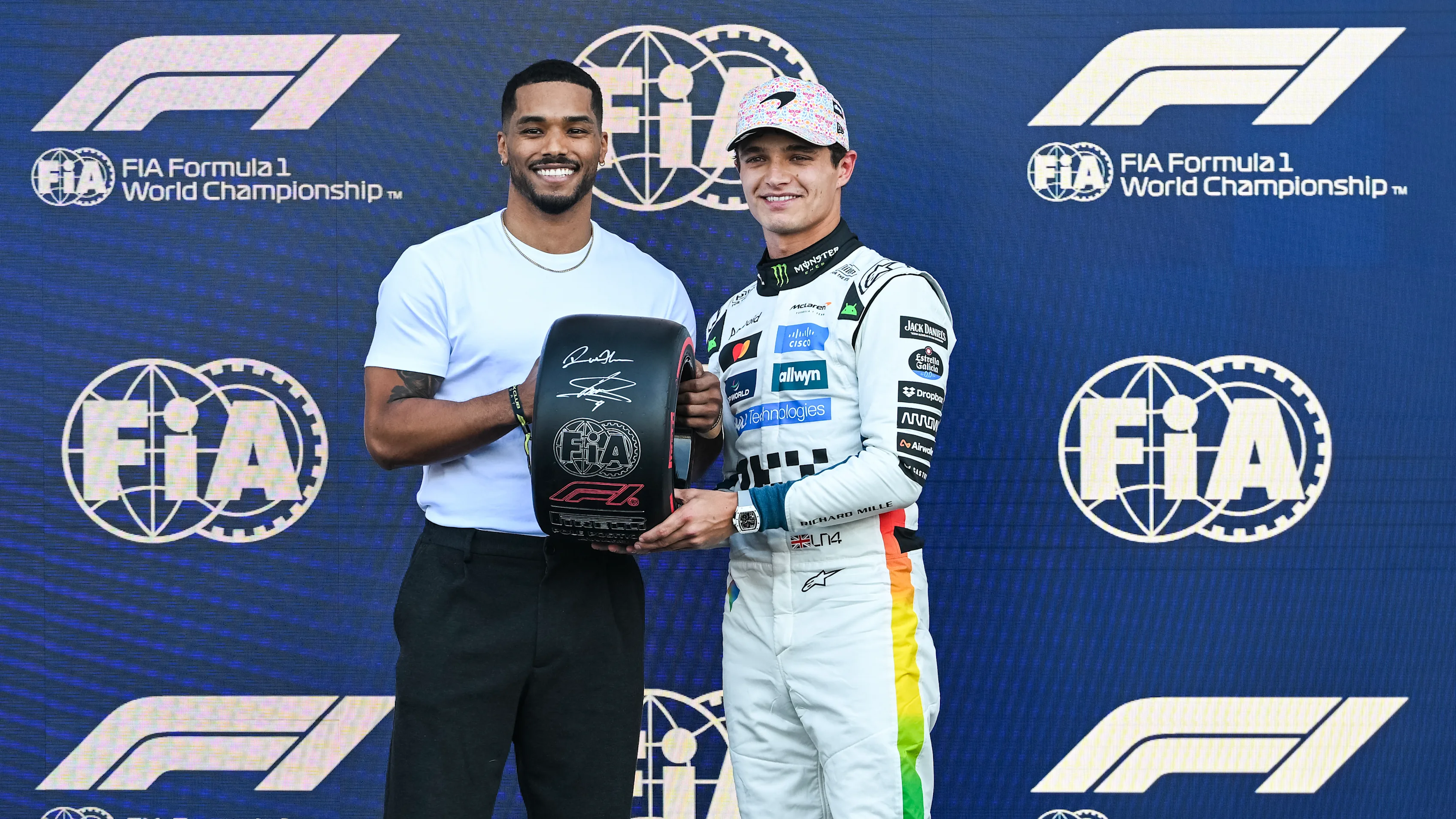 MEXICO CITY, MEXICO - OCTOBER 25: Rome Flynn presents Pole position qualifier Lando Norris of Great